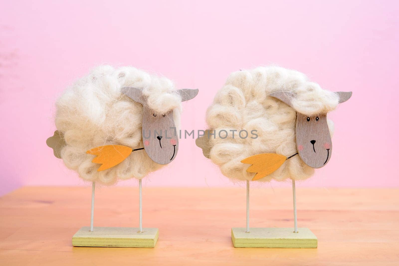 funny sheep with flower in front of pink background