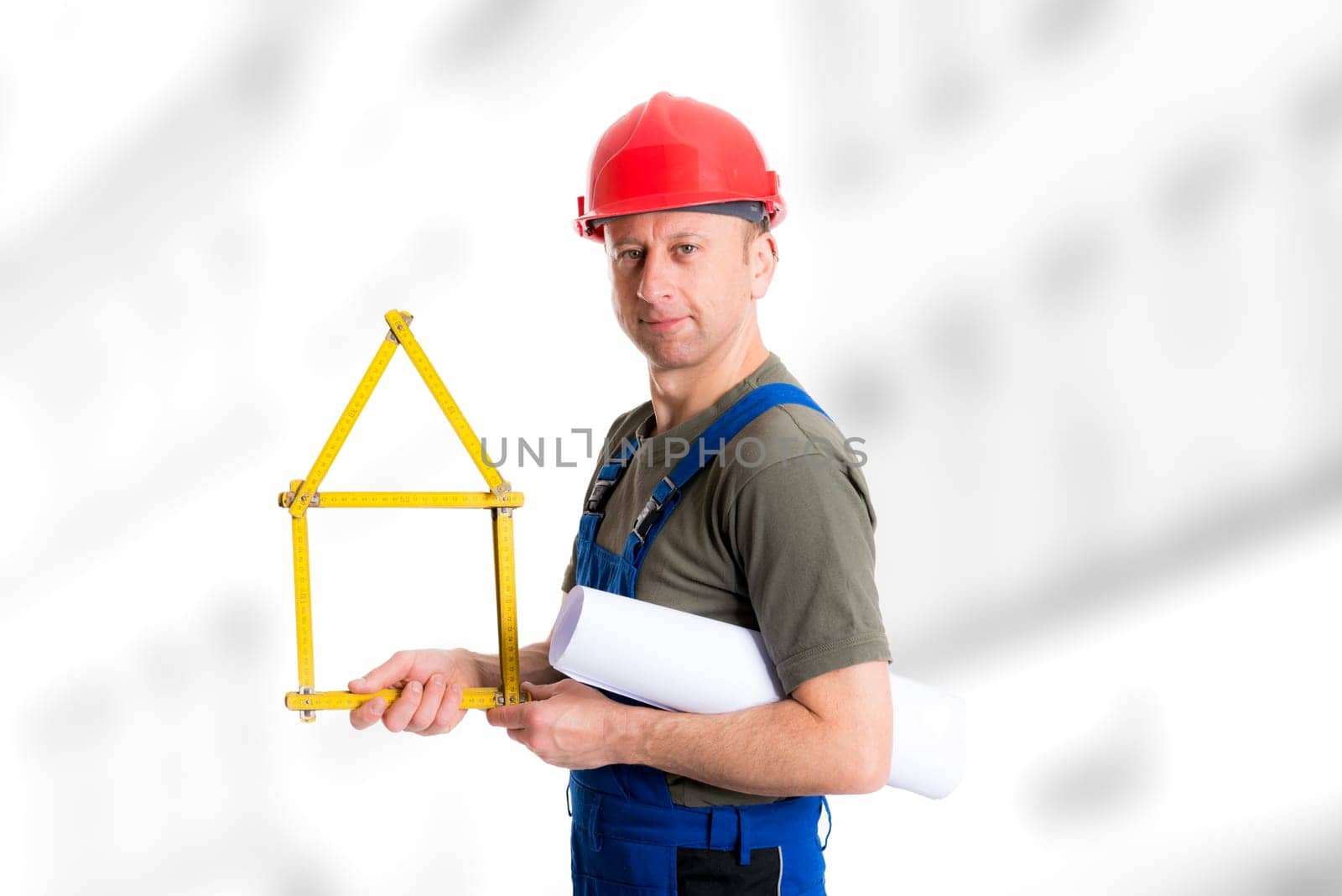 young worker with yardstick- house and blueprint