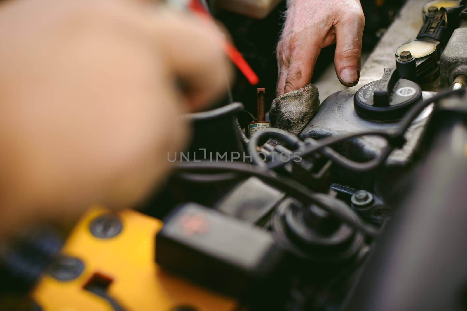 hands of an auto mechanic close-up. servicing and caring for a car engine