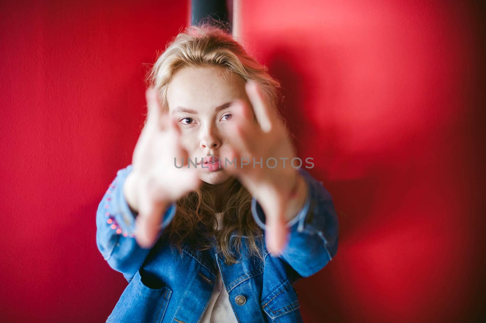 young beautiful woman in jeans clothes in parking of shopping center. portrait of a girl with freckles on her face