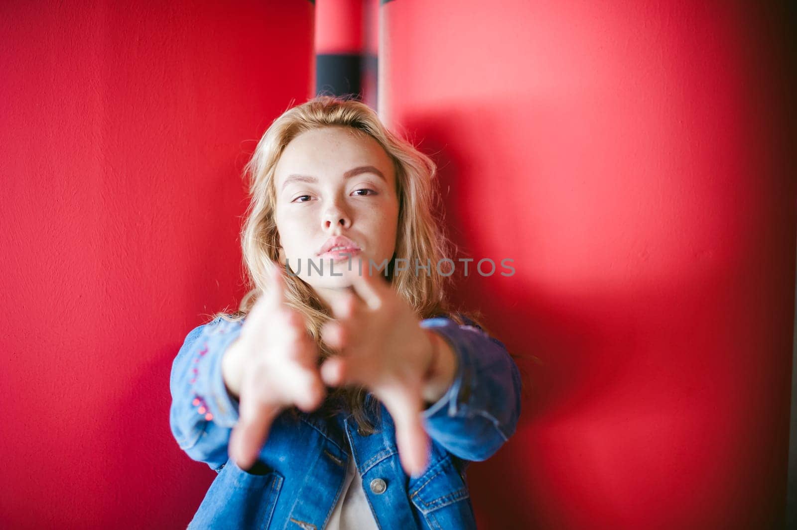 young beautiful woman in jeans clothes in parking of shopping center. portrait of a girl with freckles on her face