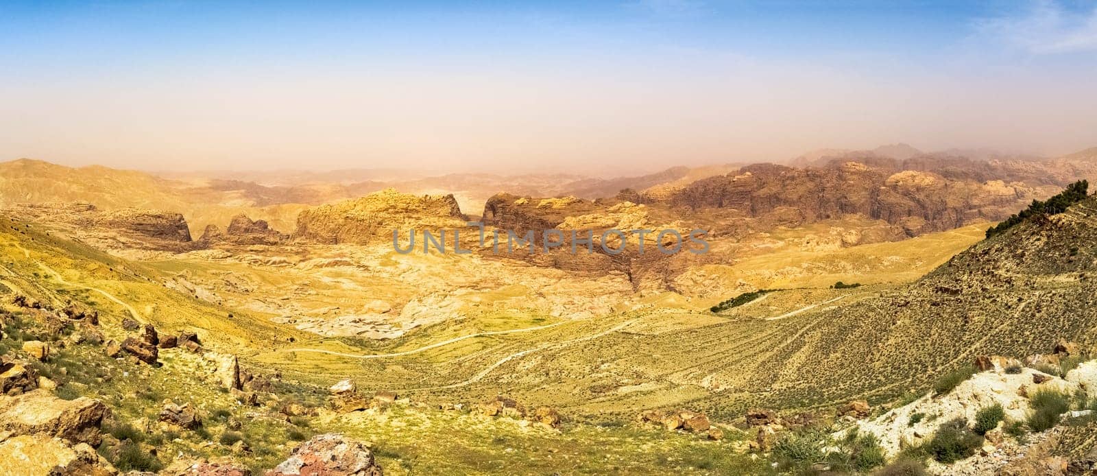 Travel to Middle East country Kingdom of Jordan - blue sky over mountain around Wadi Araba (Arabah, Arava, Aravah) area near Petra town in sunny spring day.