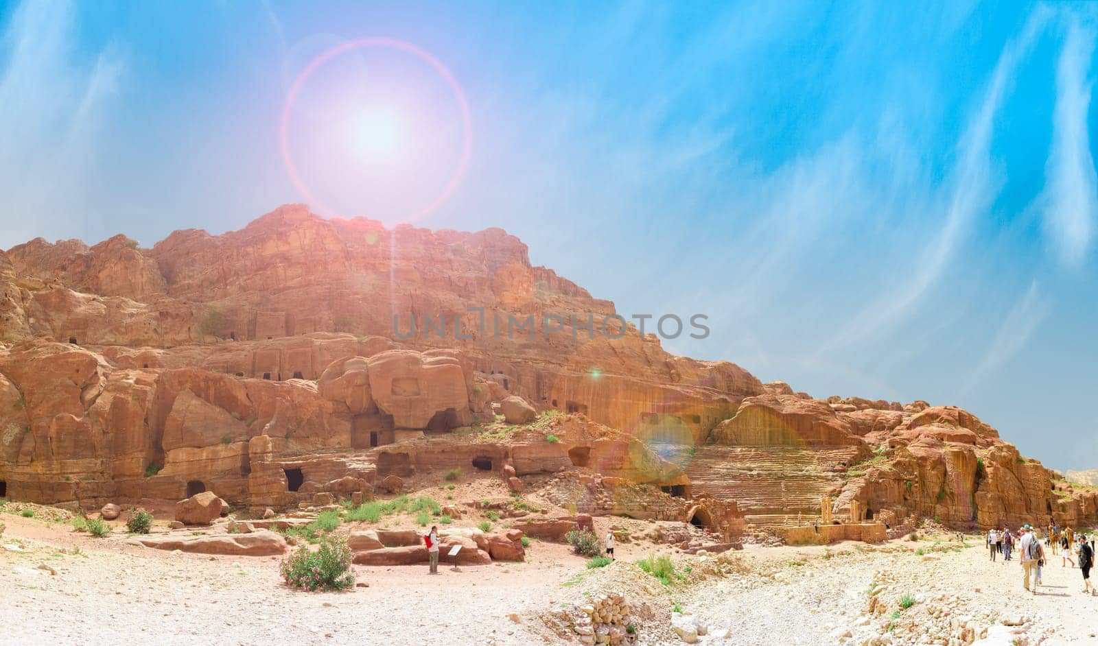 PETRA, JORDAN - APRIL 25, 2016: Tourists visit the Petra's ancient amphitheater.Temples, tombs, theatres and other buildings are scattered over 400 square miles.