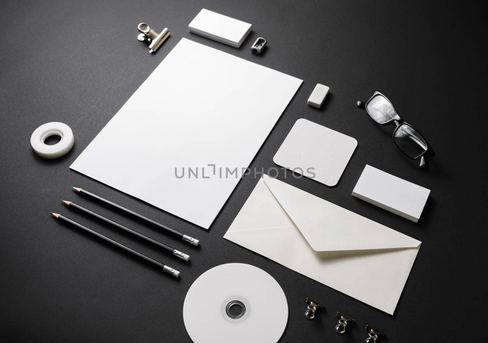 Branding mock up. Blank corporate stationery set on black paper background.