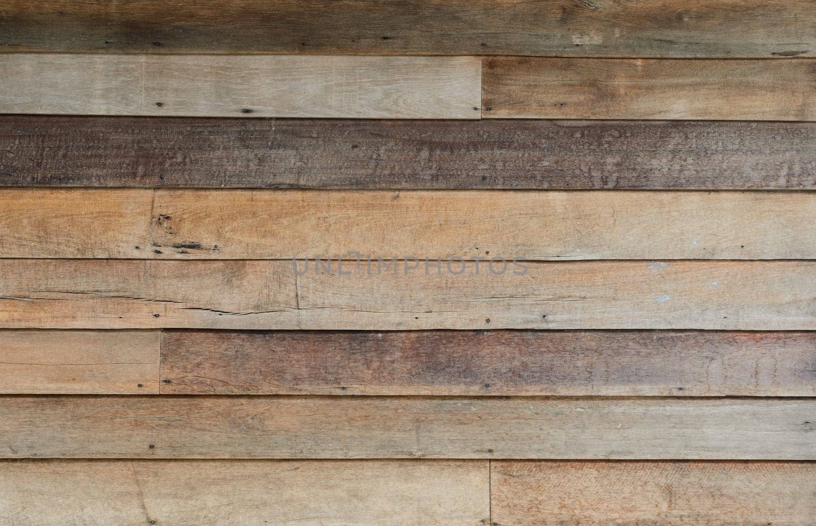 Rough wooden wall with the hammered nails background