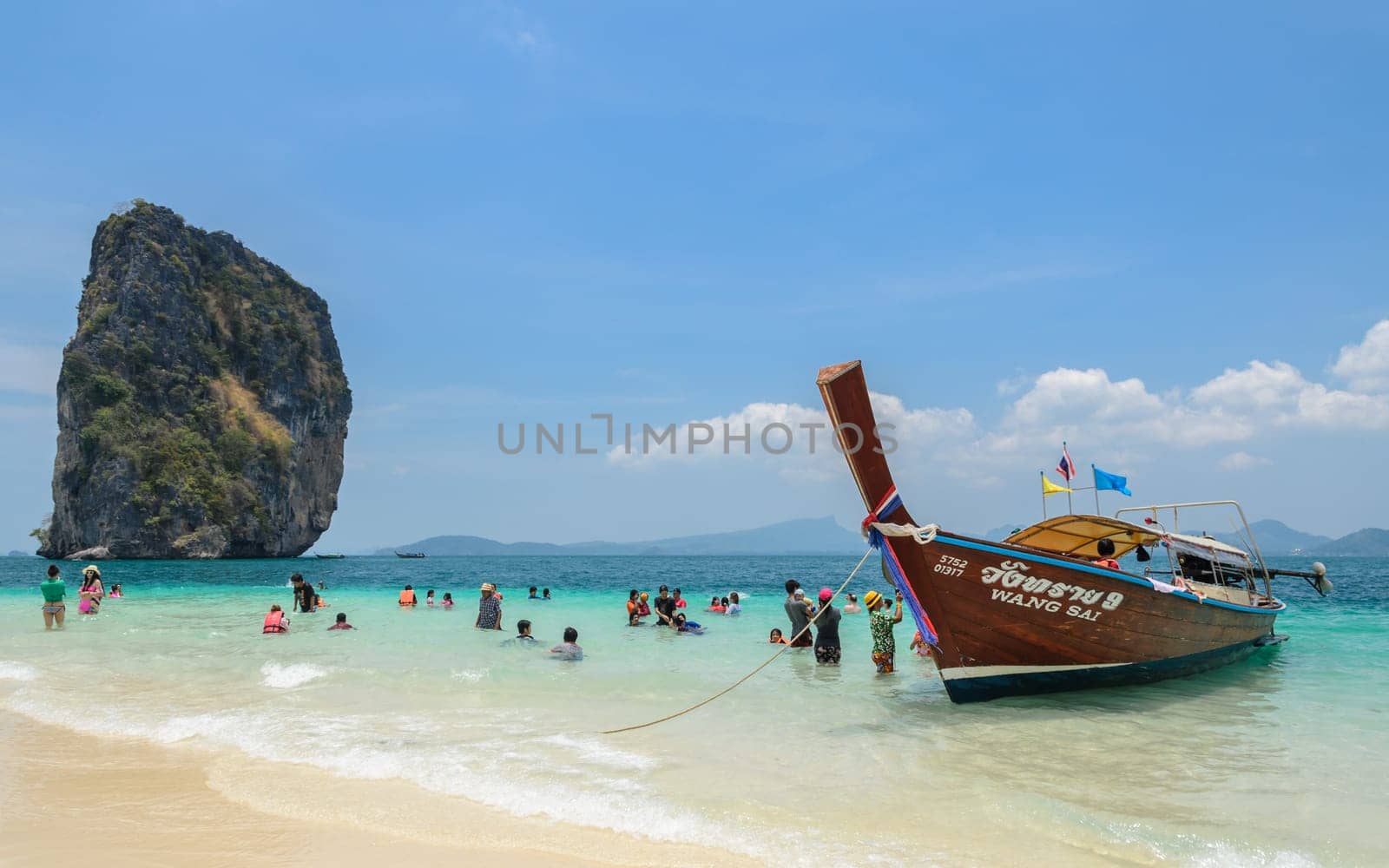 KRABI, THAILAND - APRIL 12, 2016 : Poda Island, white sandy beach with turquoise andaman sea water and long-tailed boat taxi in Krabi province, Thailand.