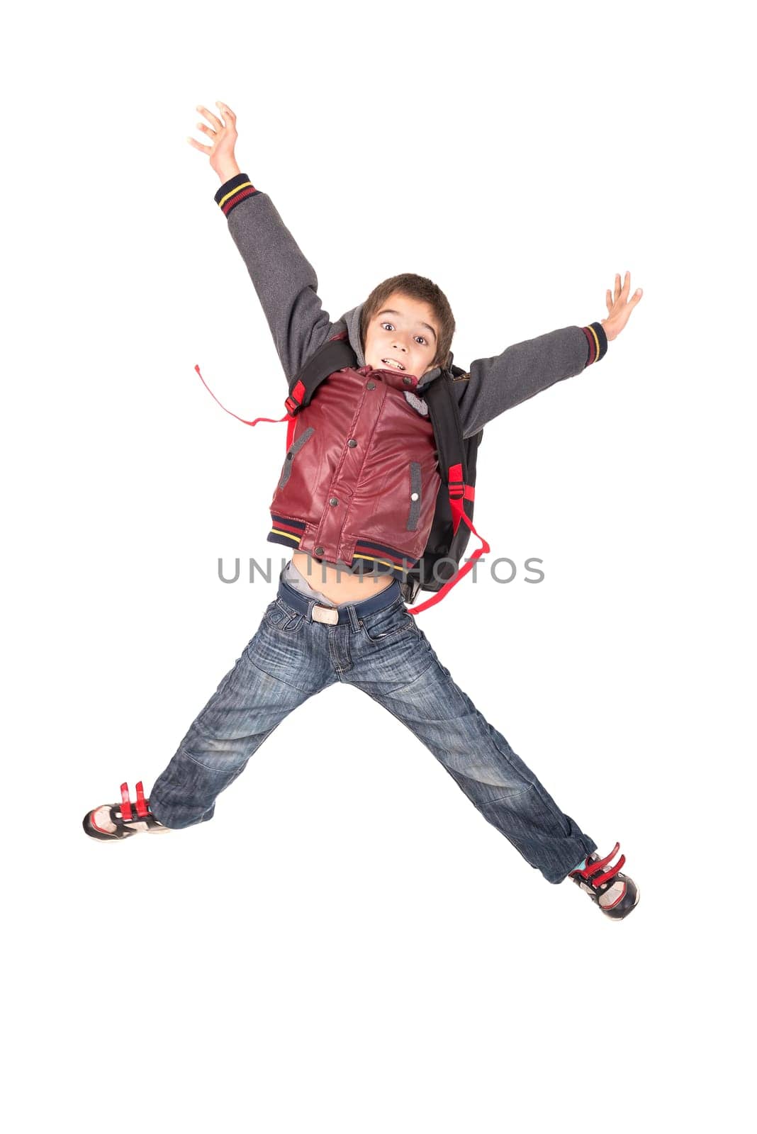 Young boy student jumping isolated in white