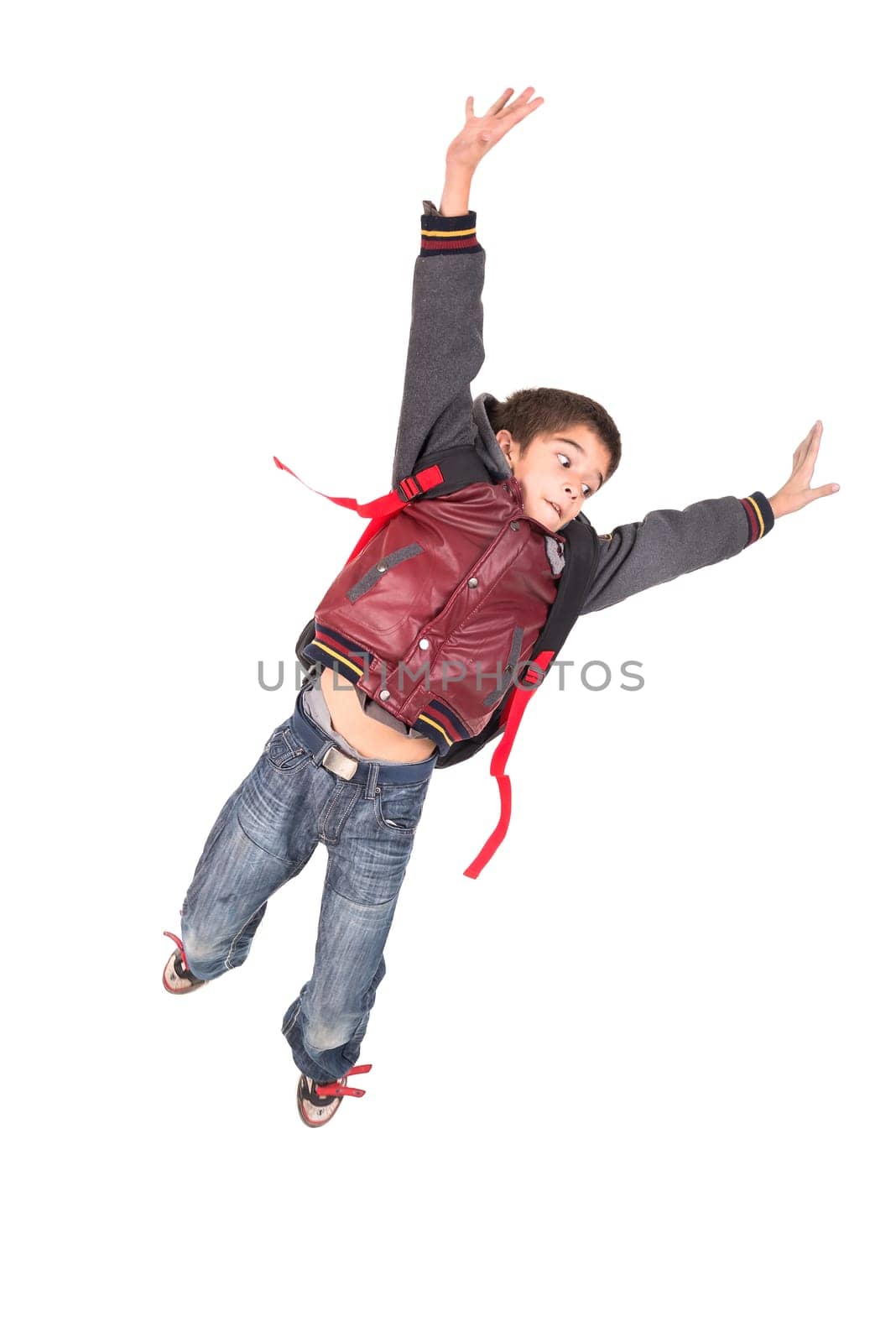 Young boy student jumping isolated in white