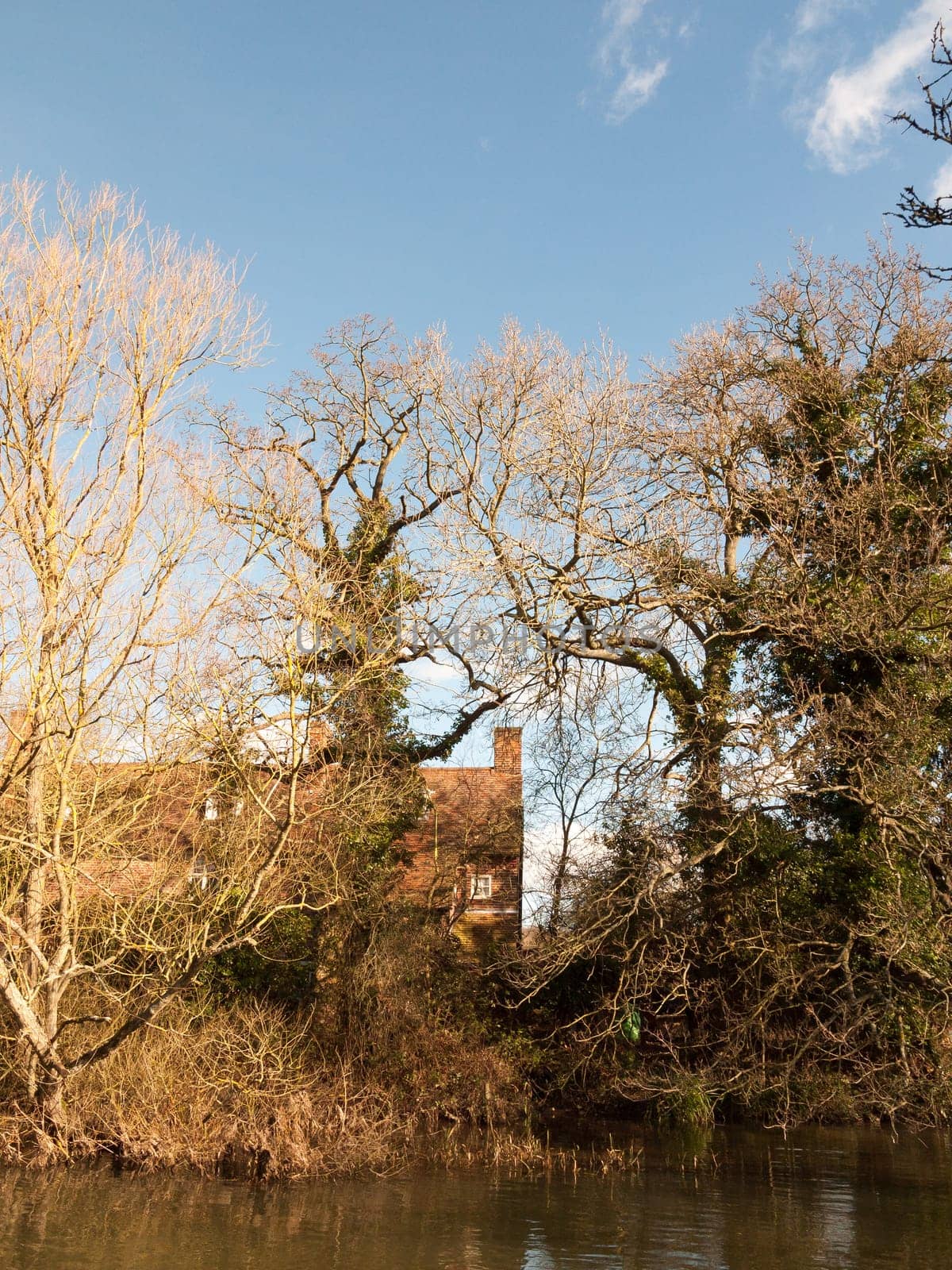 flatford mill house spring from across the lake on side river stour constable country close up  essex  england  uk