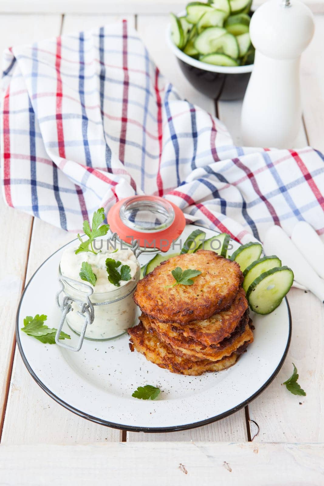 Fresh potato pancakes and cottage cheese with fresh herbs