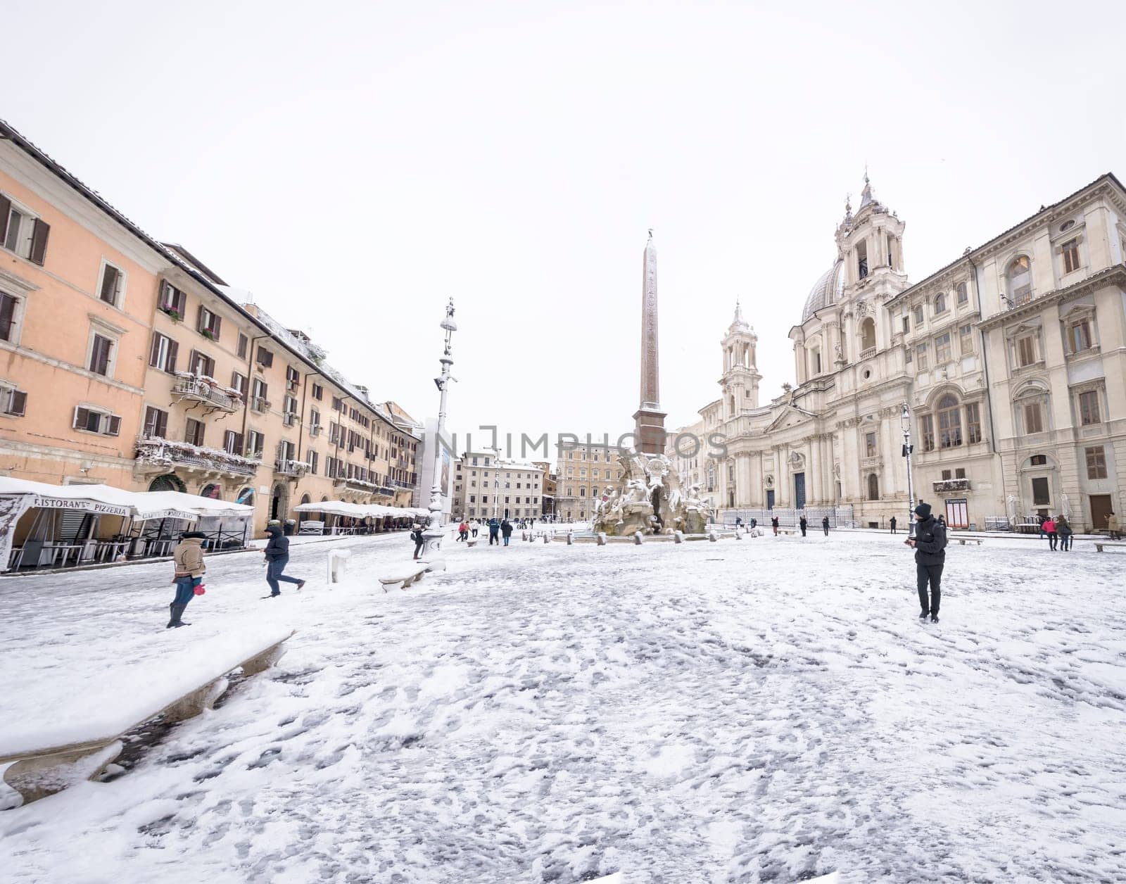 Rome, Italy, february 26th, 2018: Piazza Navona in Rome covered with snow with citizens and tourists walking in wonder after the unusual snowfall of February 26th 2018