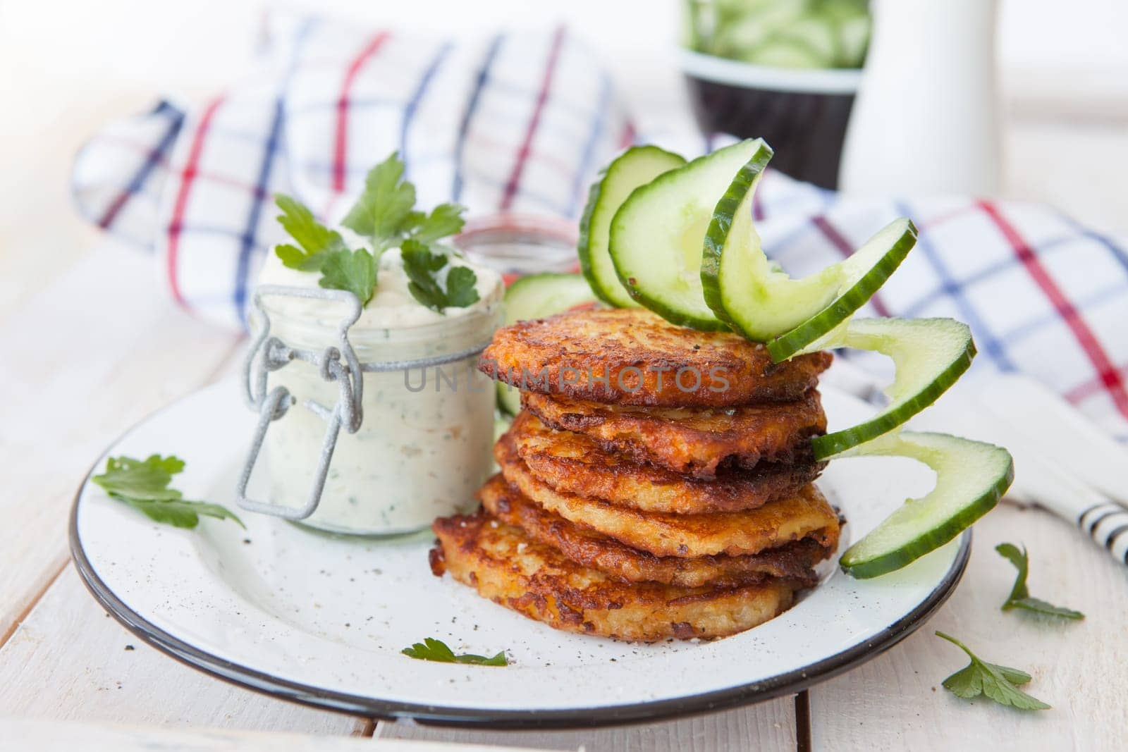 Fresh potato pancakes and cottage cheese with fresh herbs