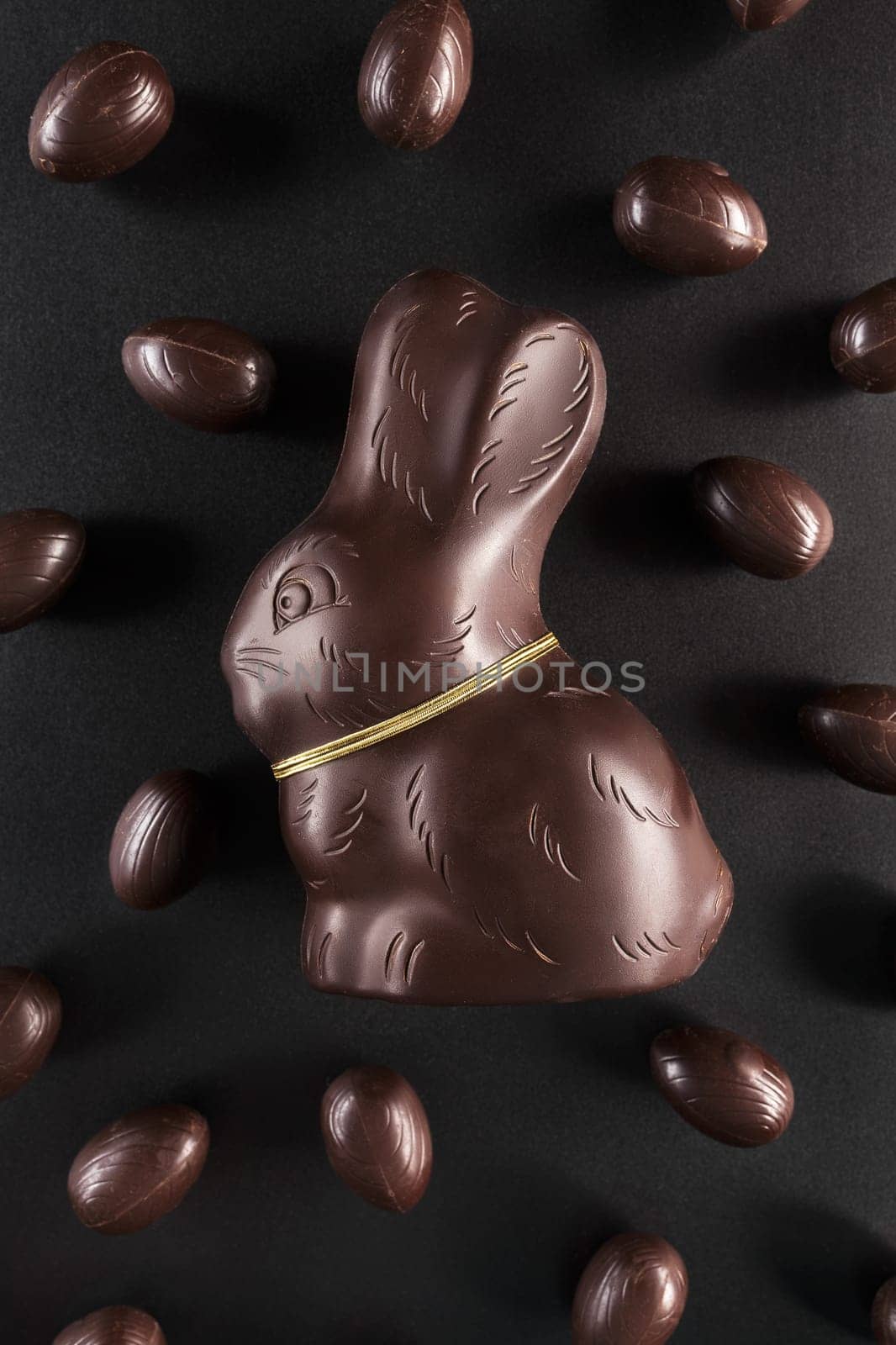 Delicious chocolate Easter bunny and eggs on dark background