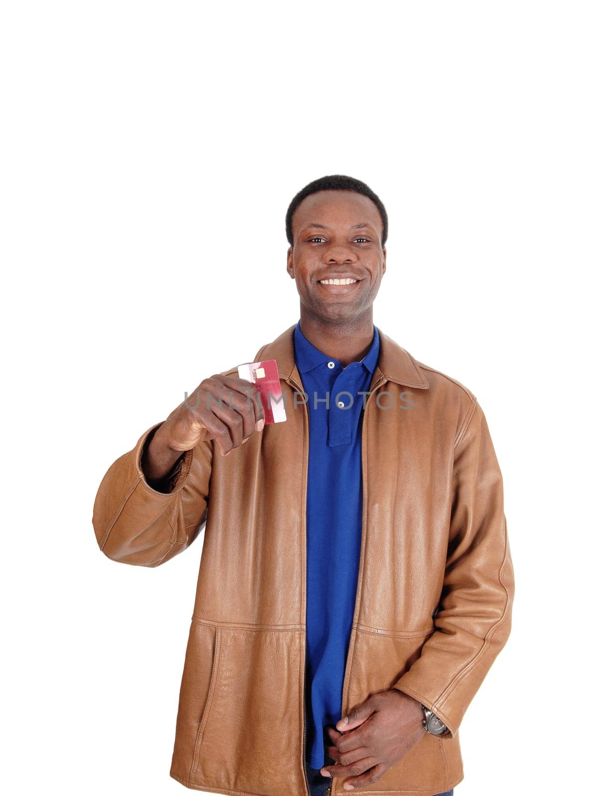 A very happy African American man standing in a brown leather jacket.and showing his new credit card, isolated for white background.