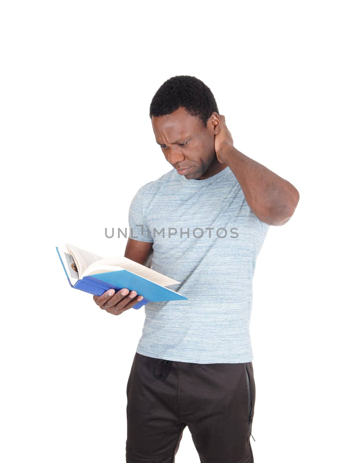 An attractive young African American man holding his book and.is wondering what he is reading, isolated for white background.