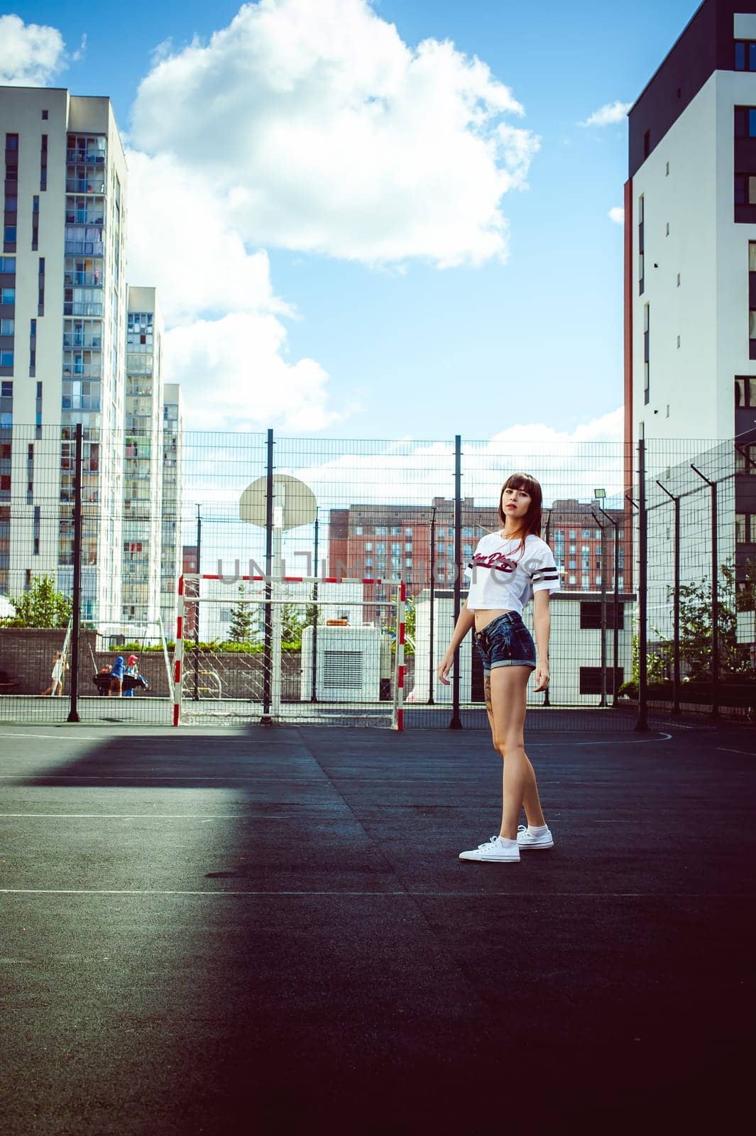 portrait attractive women in sports white T-shirt Posing on football field