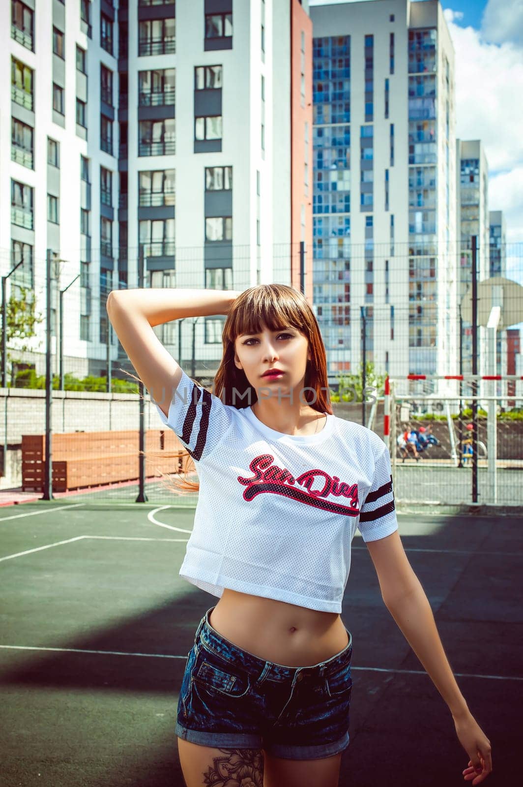 portrait attractive women in sports white T-shirt Posing on football field