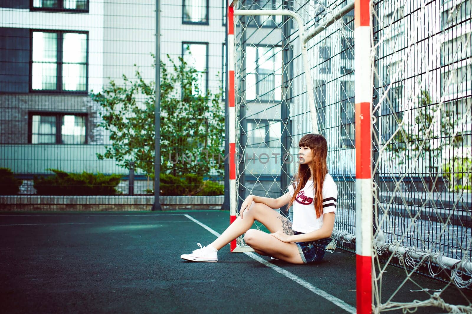 portrait attractive women in sports white T-shirt Posing on football field