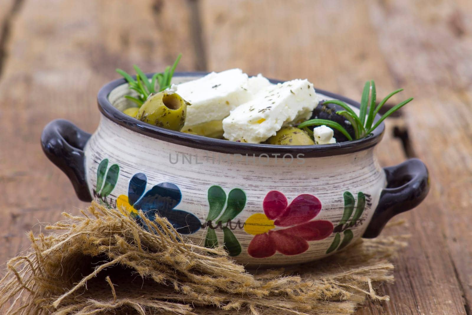 feta cheese and olives with herbs in olive oil