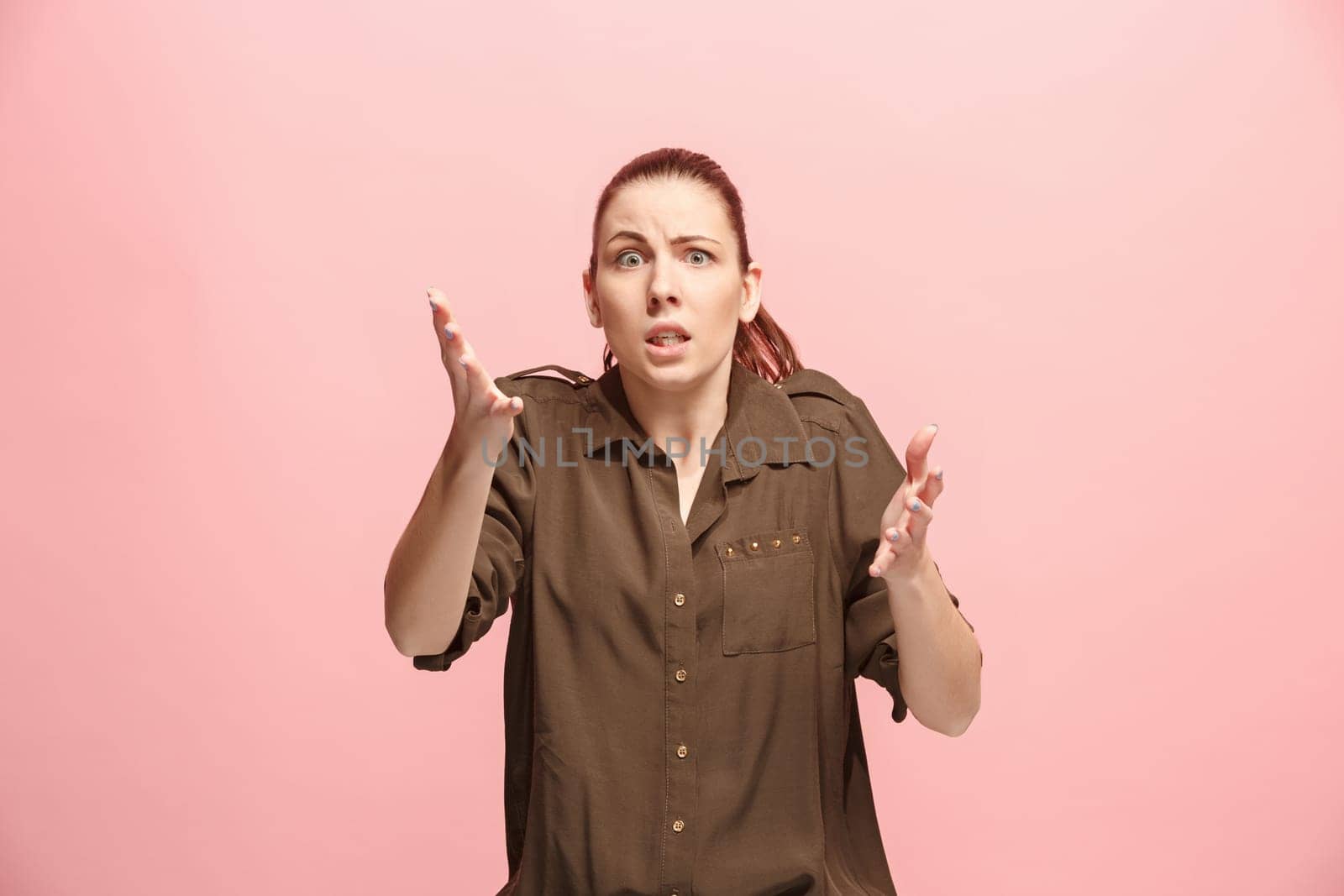 Why is that. Beautiful female half-length portrait isolated on trendy pink studio backgroud. Young emotional surprised, frustrated and bewildered woman. Human emotions, facial expression concept.
