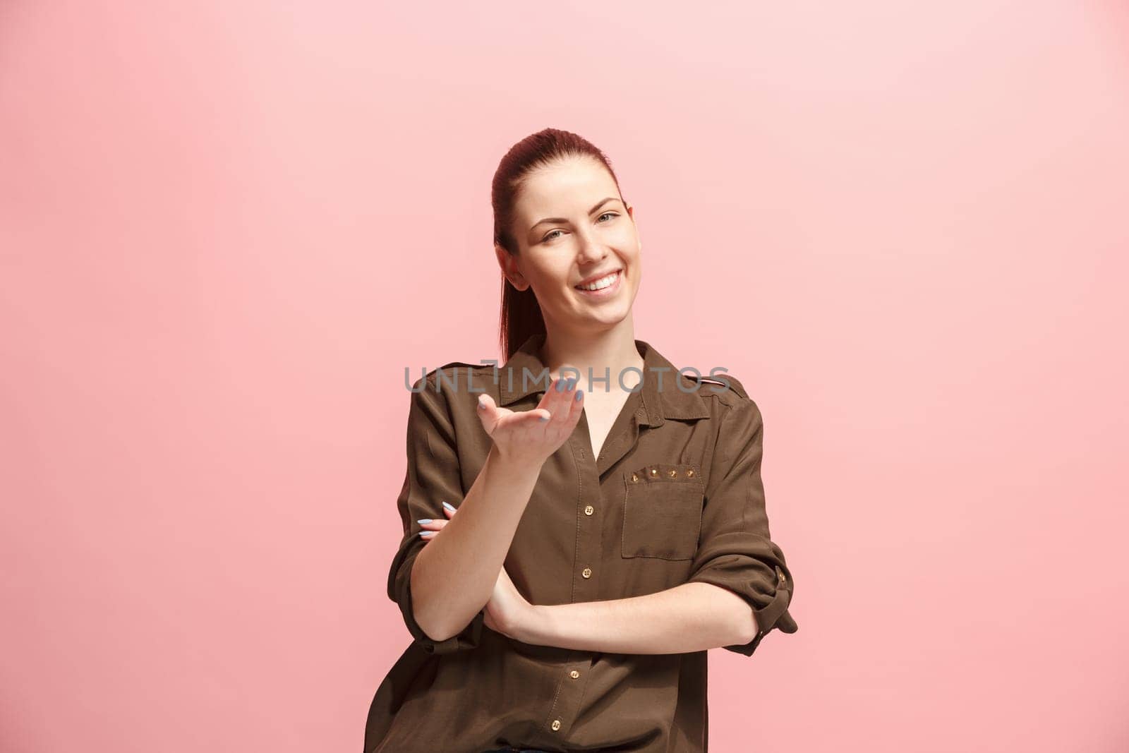 Happy business woman standing and smiling isolated on pink studio background. Beautiful female half-length portrait. Young emotional woman. The human emotions, facial expression concept. Front view.