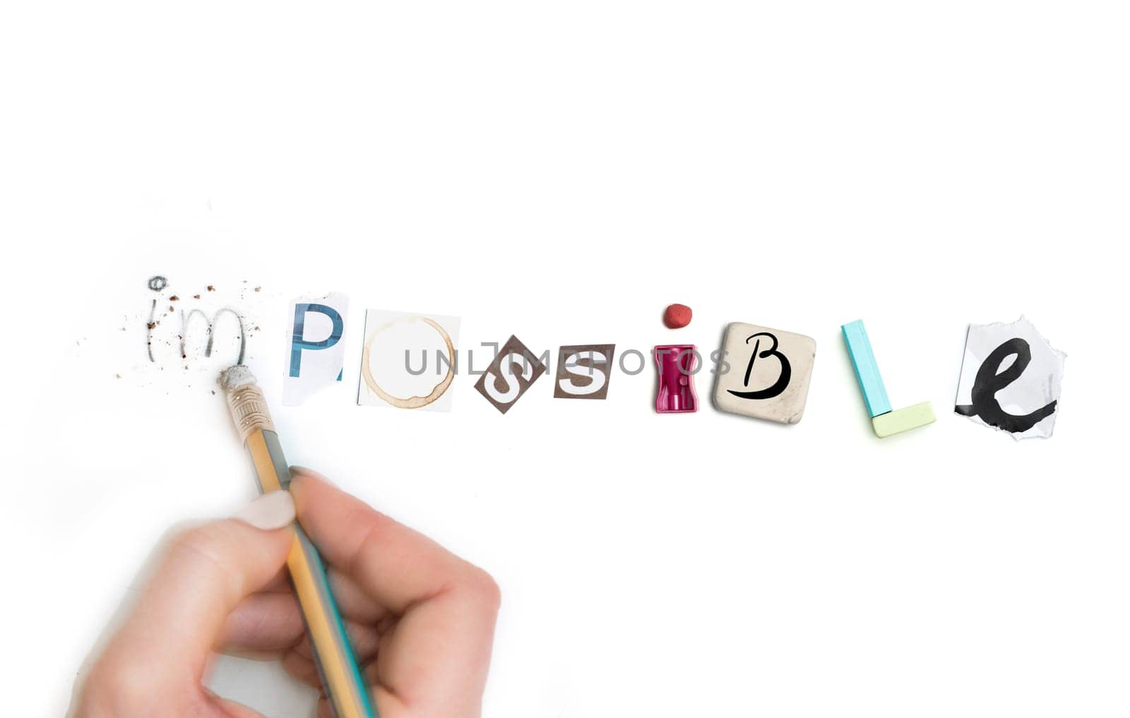 Concept of idea with colorful crumpled paper. The word Impossible created from office stationery. The art, creative, letters concepts. Conceptual image. Top view, isolated on white desk. Work tool concept