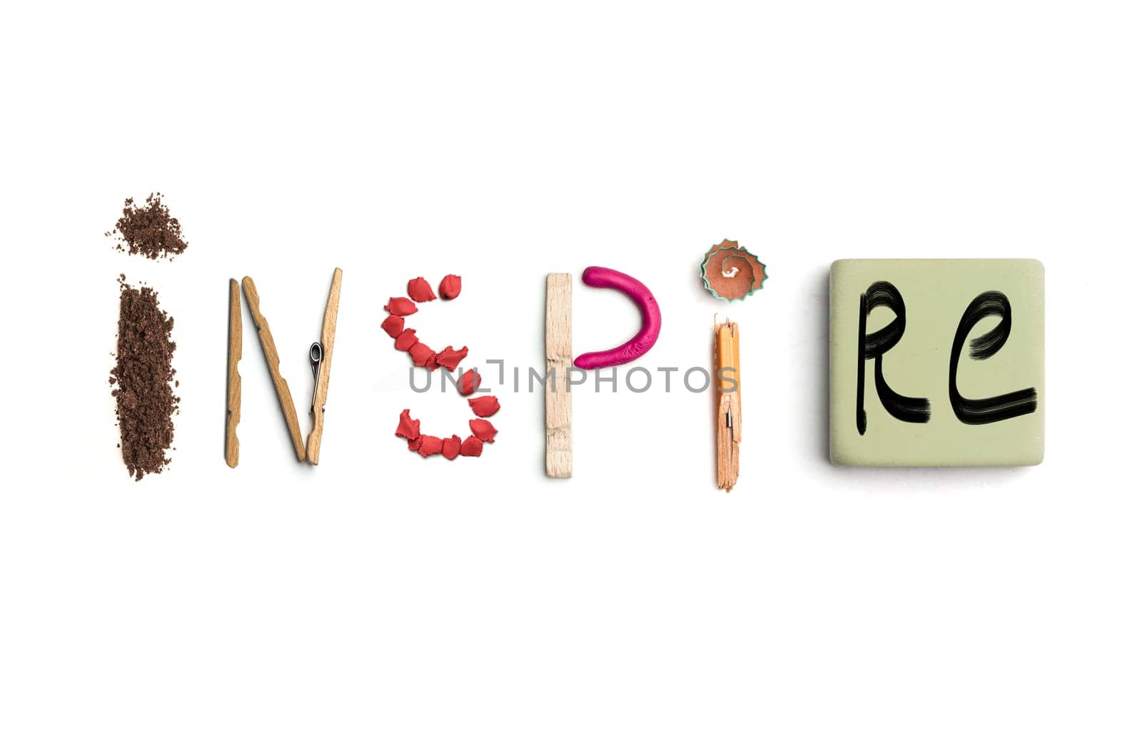 Concept of idea with colorful crumpled paper. The word inspire created from office stationery. The art, creative, letters concepts. Conceptual image. Top view, isolated on white desk. Work tool concept