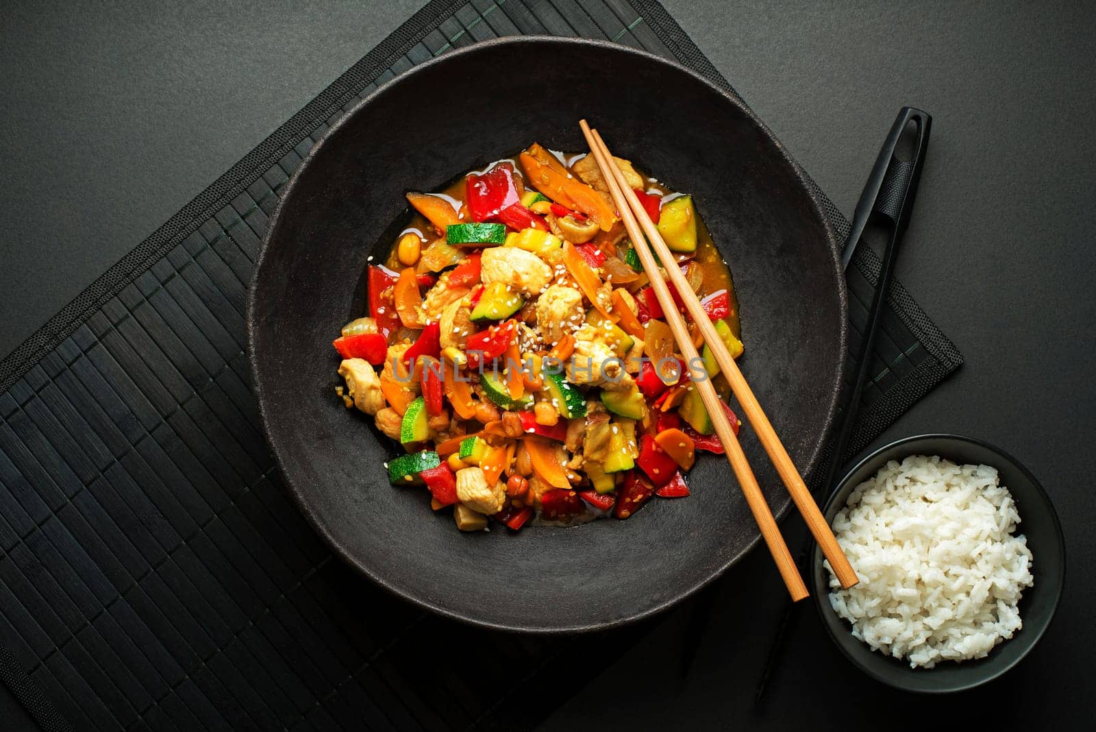 Chinese food with meat and vegetables on black background