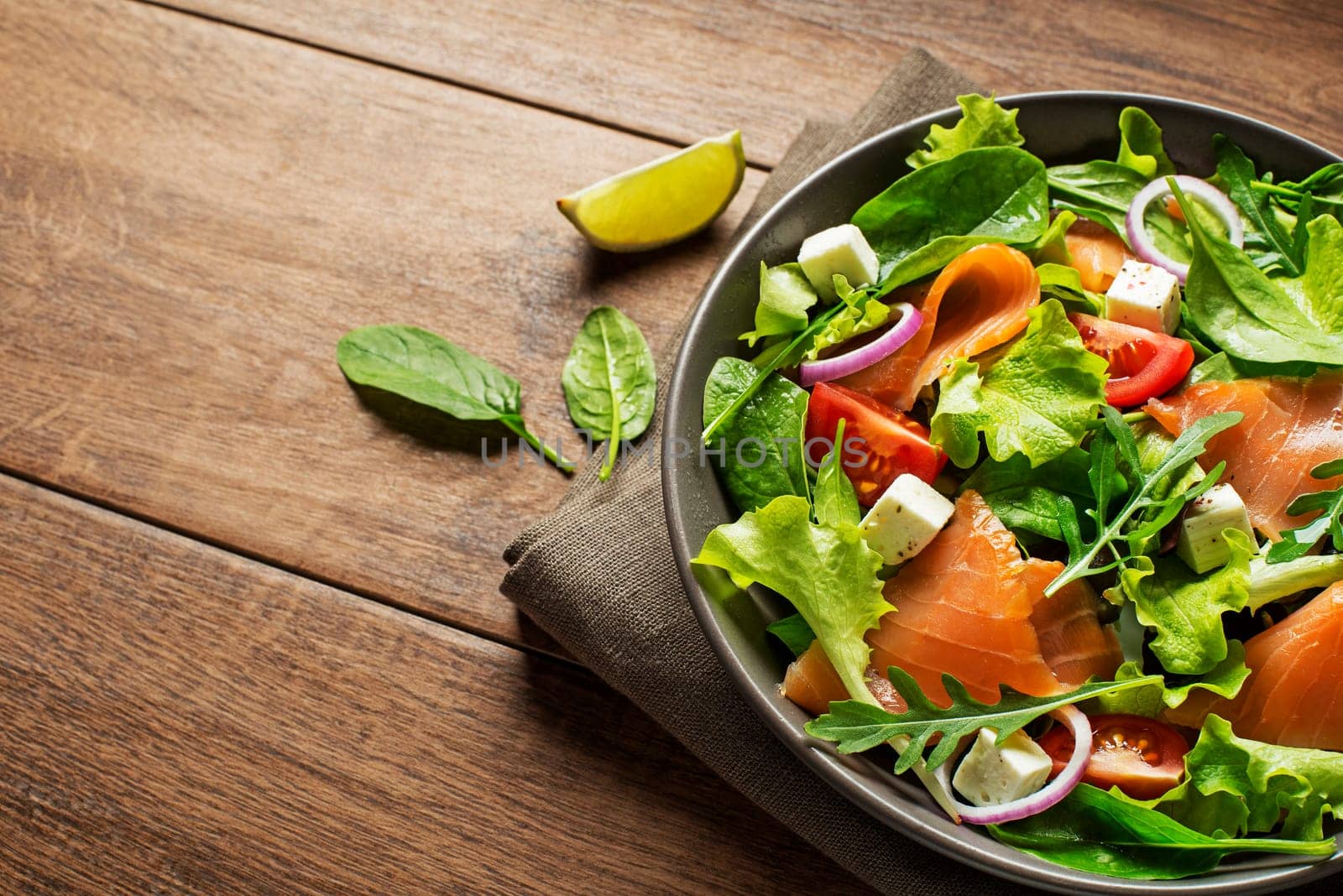 Fresh green lettuce salad with smoked salmon and cherry tomatoes