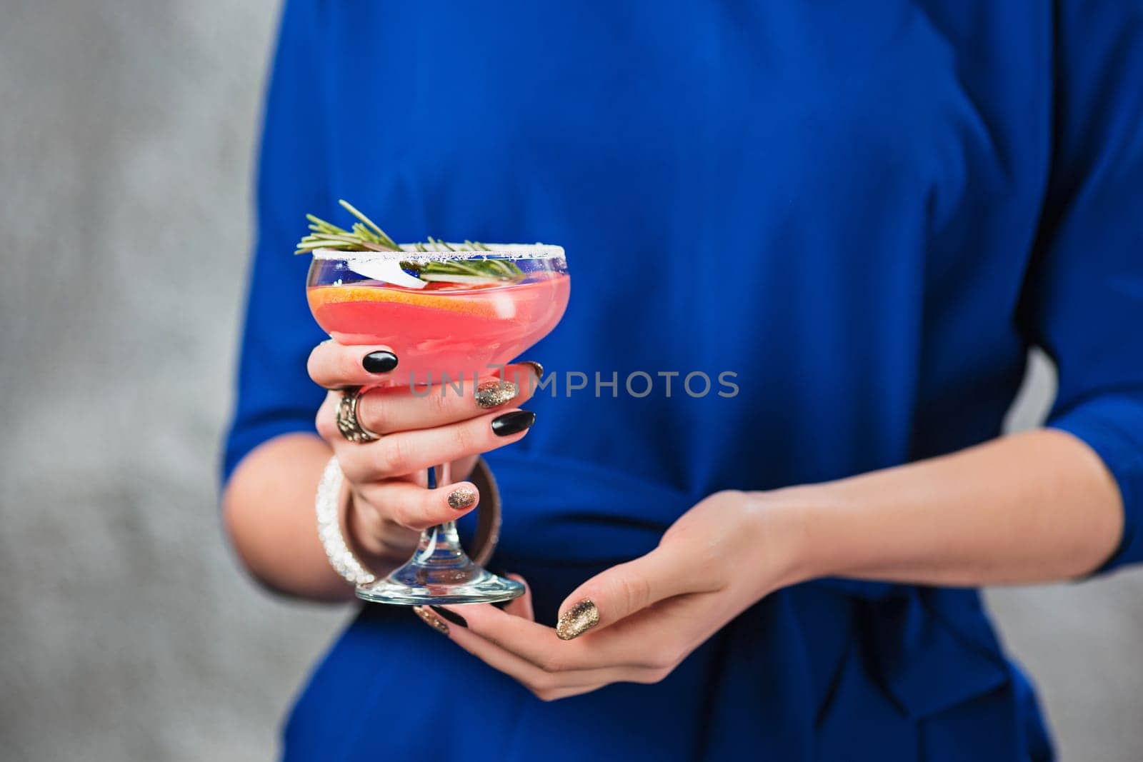 The female hands and exotic cocktail at studio