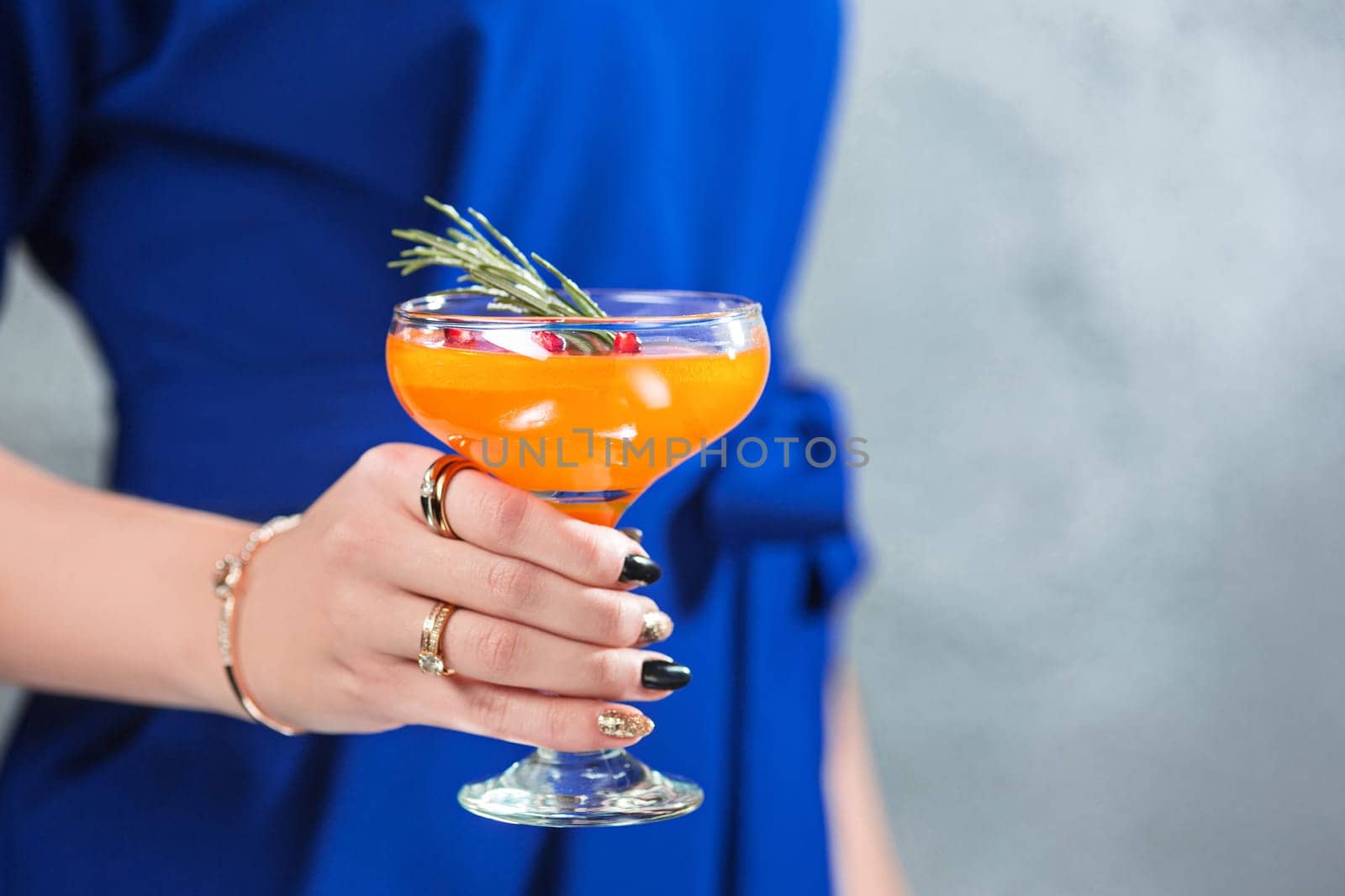 The female hands and exotic cocktail at studio