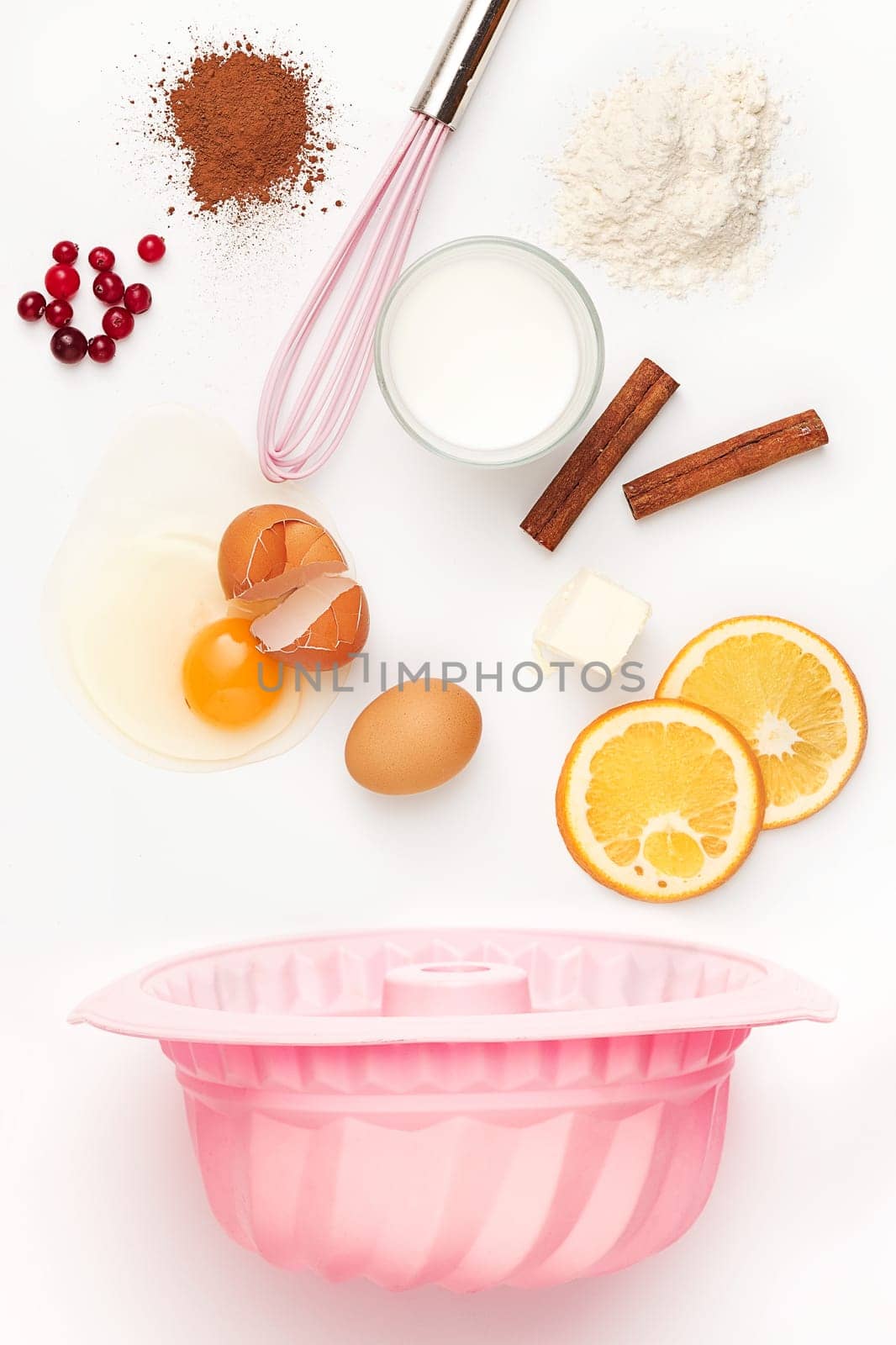 The falling ingredients of pie or cake on white table background