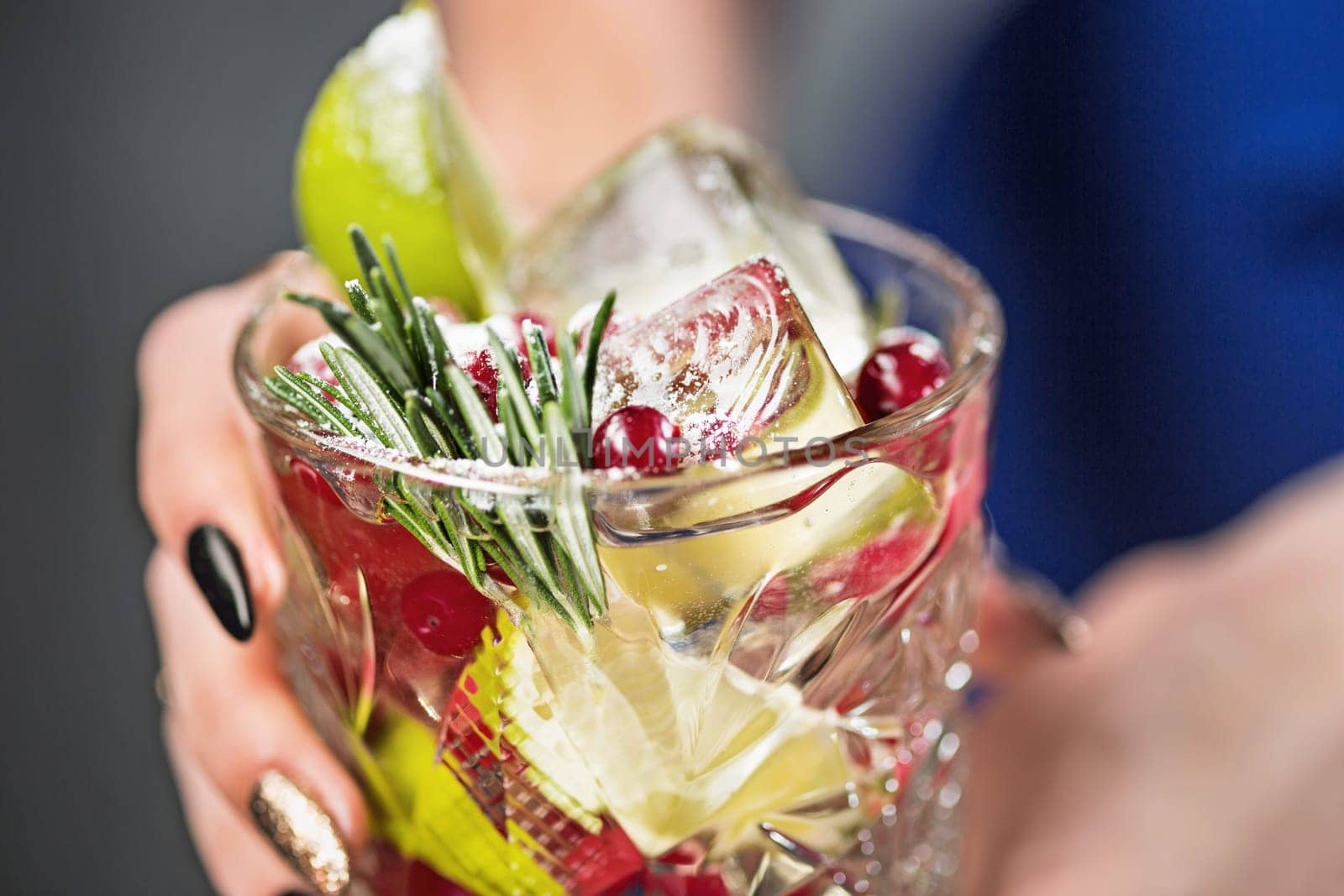 The female hands and exotic cocktail at studio