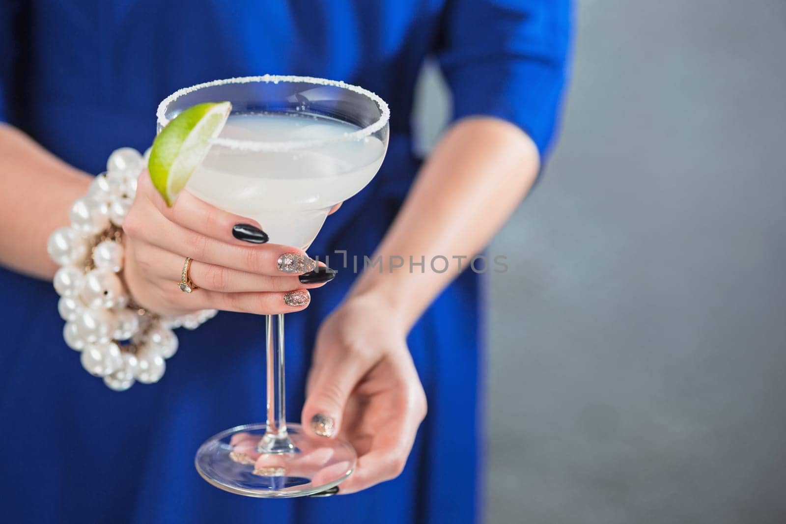 The female hands and exotic cocktail at studio