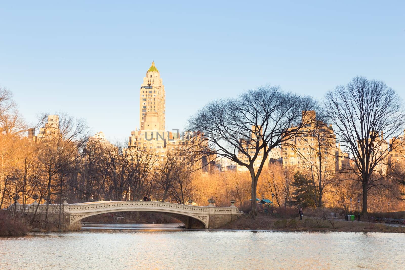New York City Manhattan Central Park panorama of The lake with Bow bridge, skyscrapers and colorful trees in autumn.