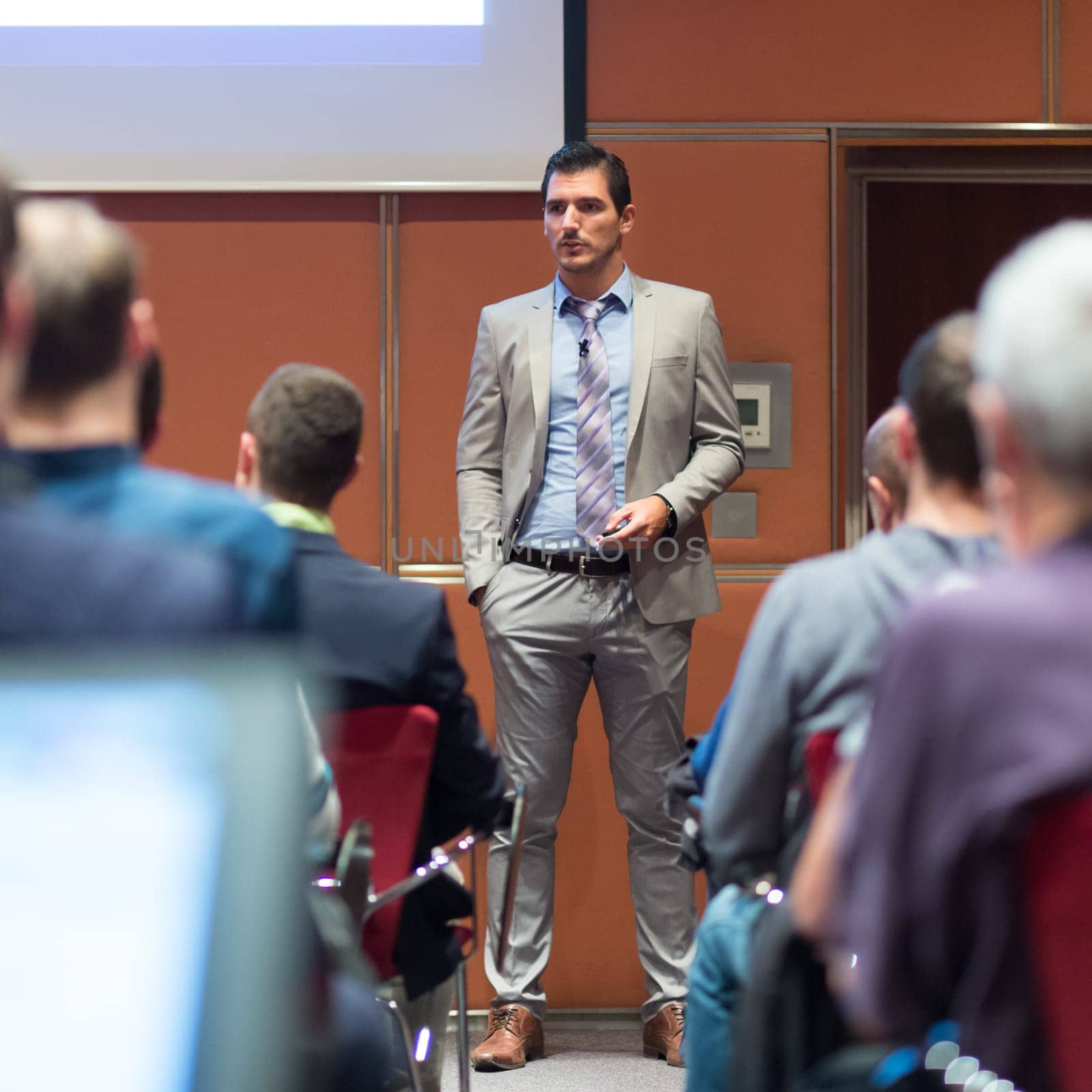 Speaker Giving a Talk at Business Meeting. Audience in the conference hall. Business and Entrepreneurship concept.