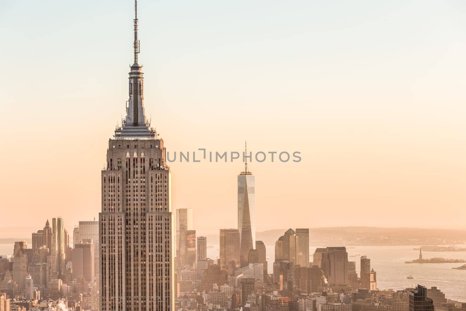 New York City. Manhattan downtown skyline with illuminated Empire State Building and skyscrapers at sunset. USA.
