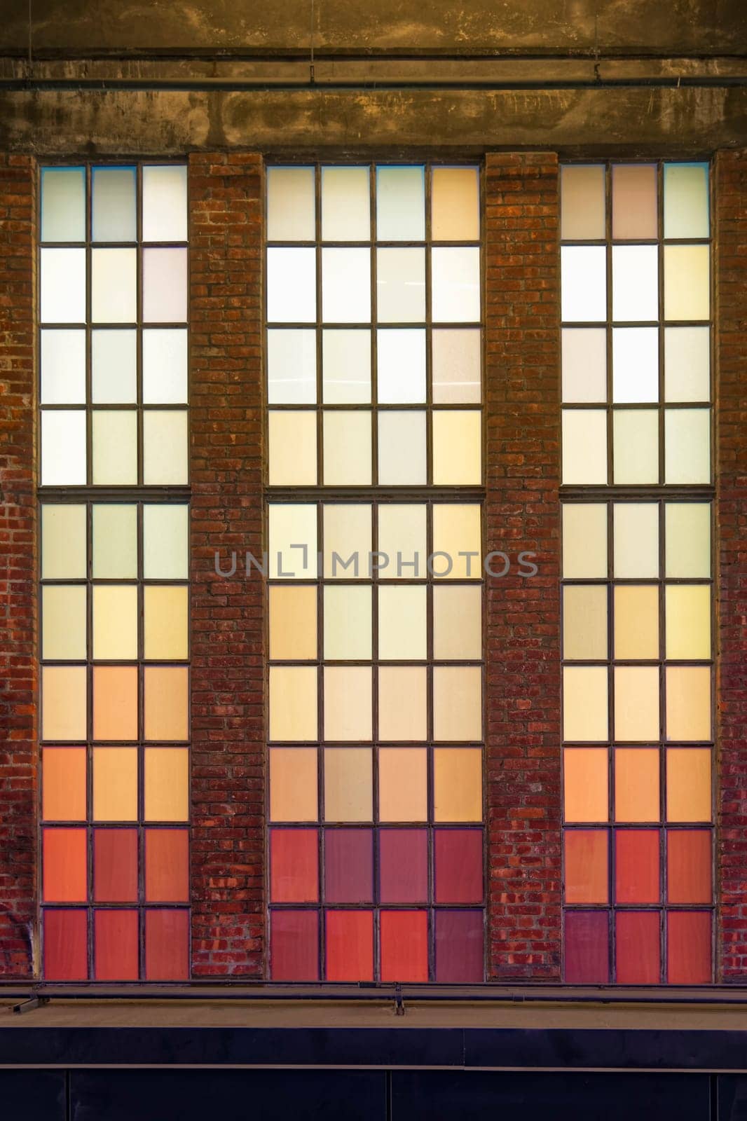 Old colored windows with warm shades. Red, orange, yellow squares.