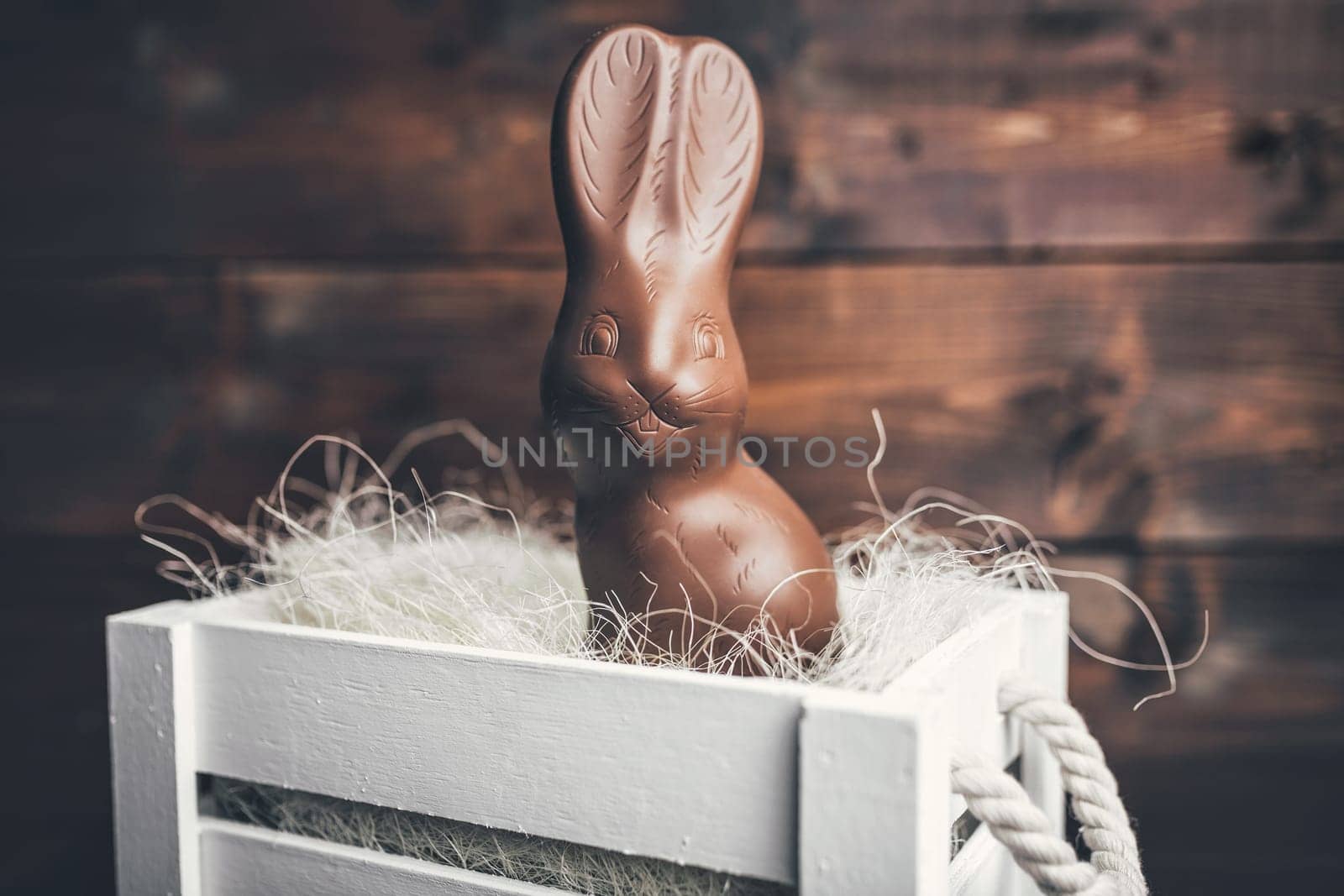 Delicious chocolate Easter bunny inside a basket