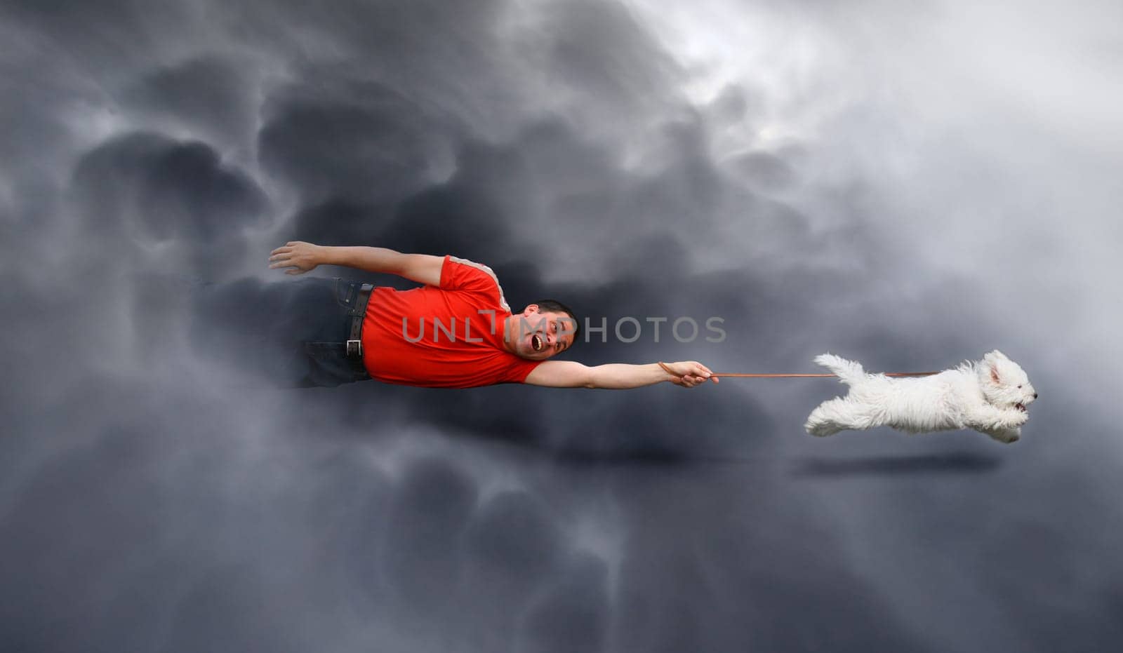 Dog running and dragging a man by the leash through the clouds. Canine education.