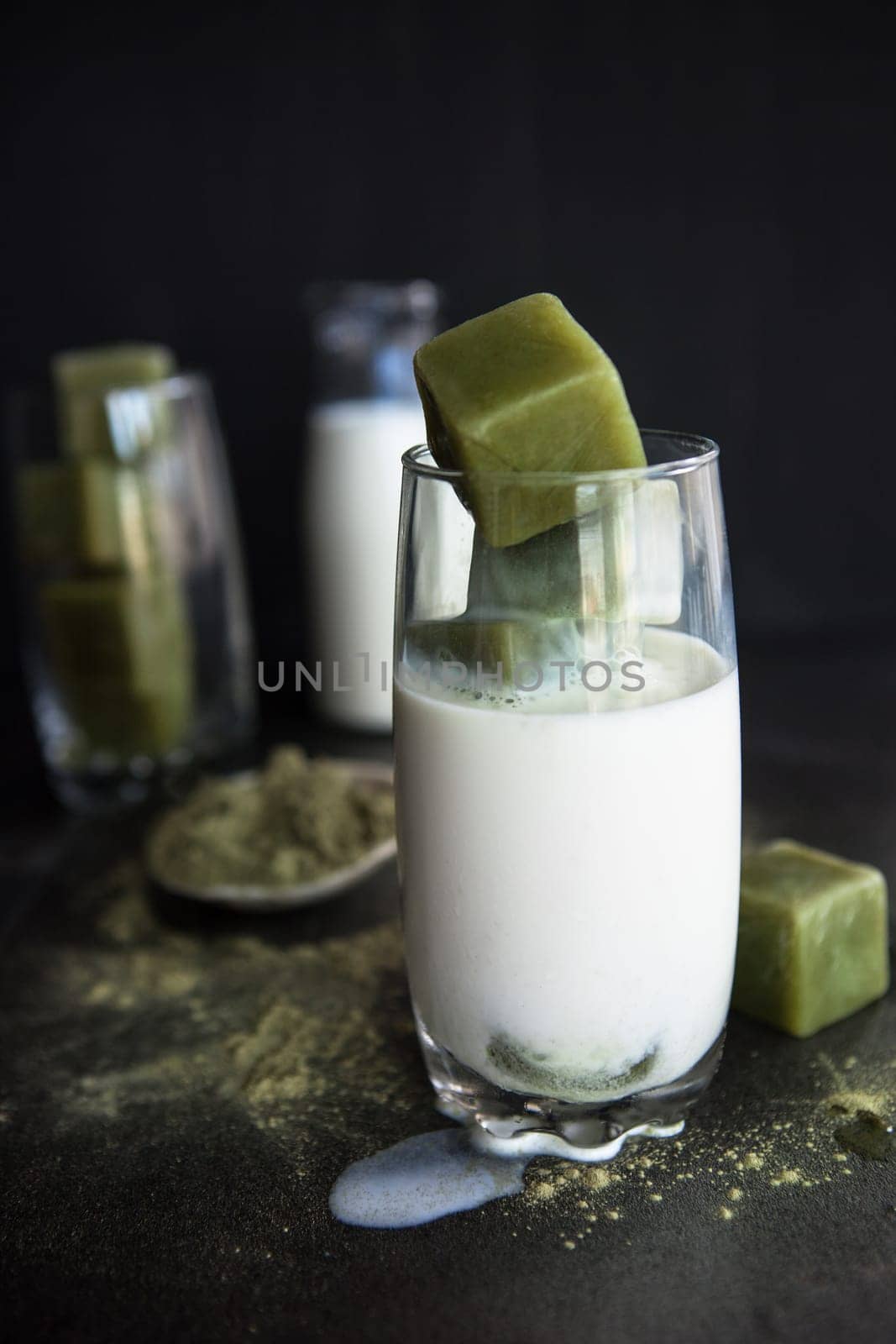 Glass of iced tea with green tea and milk