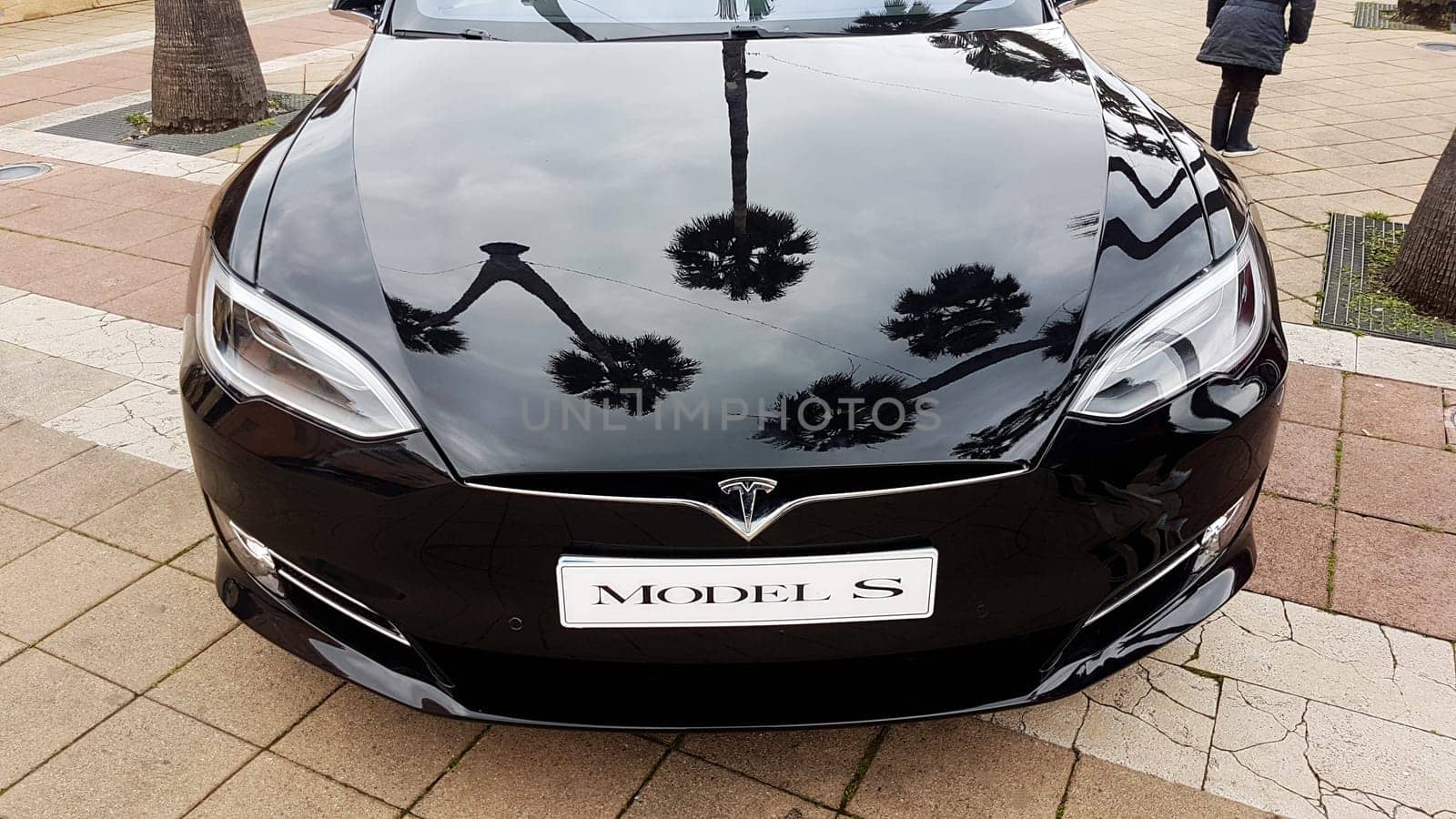 Menton, France - March 3, 2018: Black Tesla Model S (Front View) Electric Car Parked on a Square in Menton on The French Riviera. The Tesla Model S is a Luxury Full-Sized Electric Five Door .