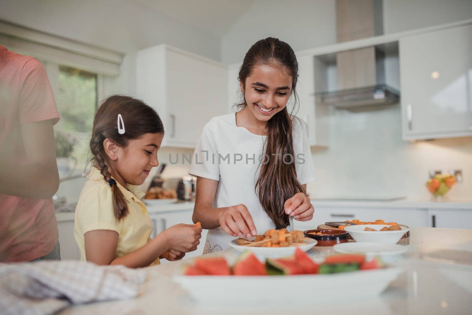 Two young girls preparing party food