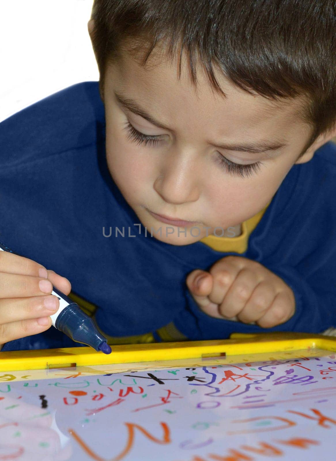 Little boy learning to write