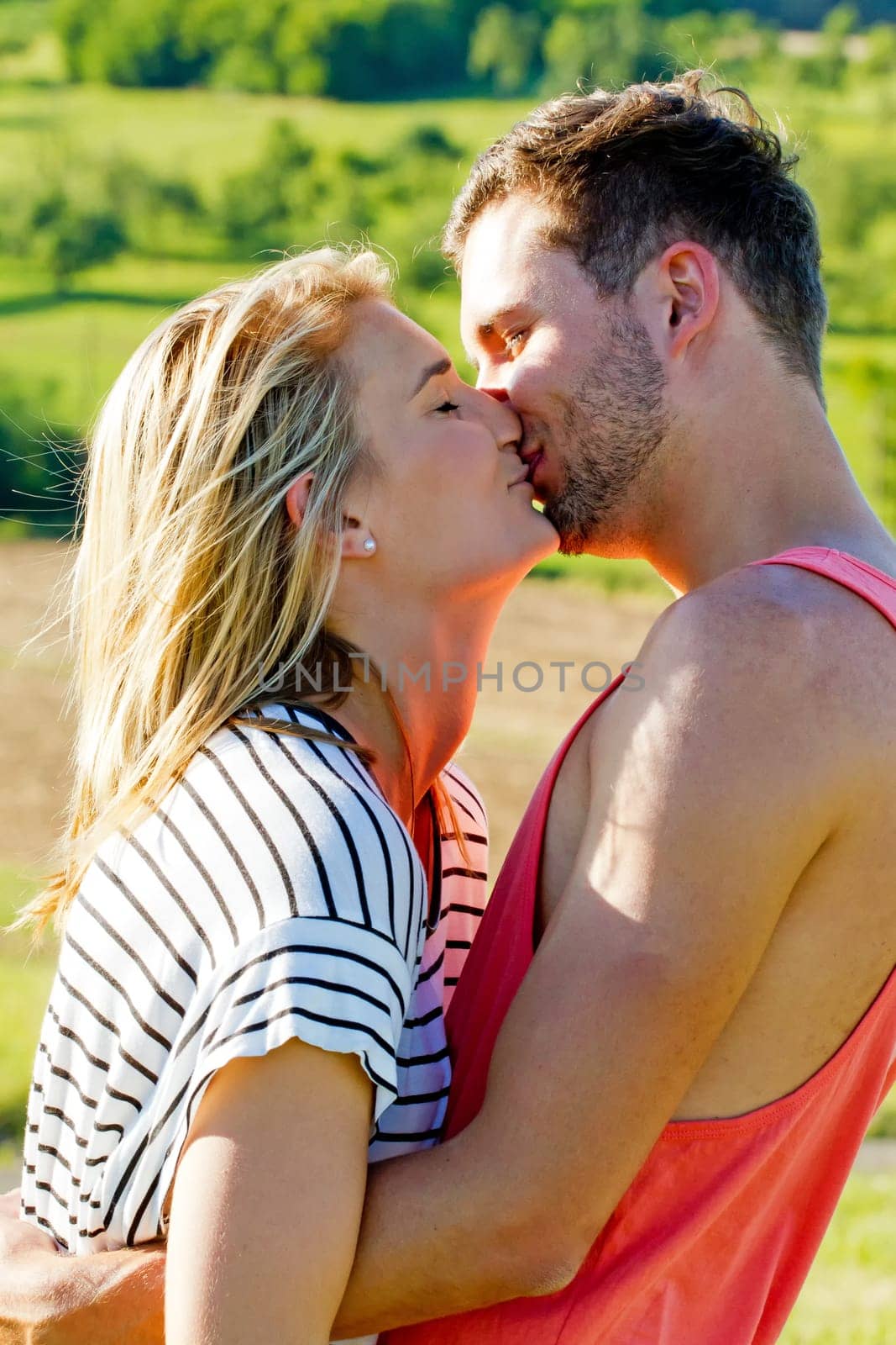 Young,happy couple kisses