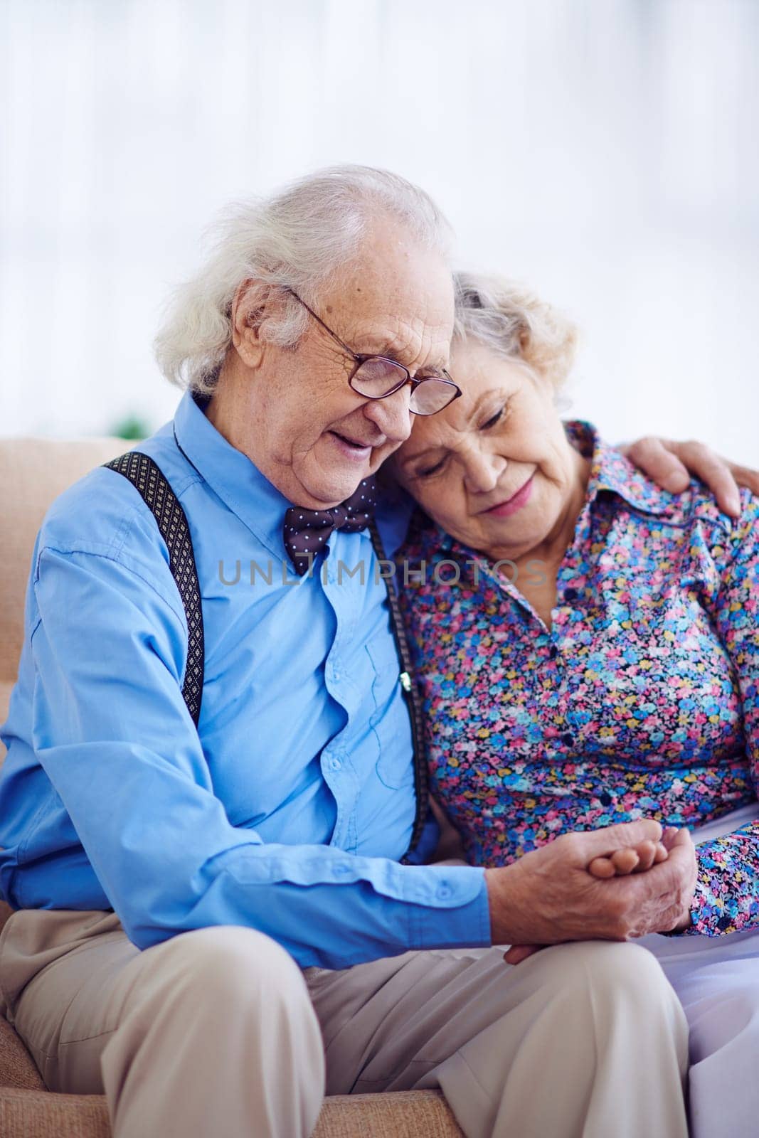Amorous couple of pensioners in smart clothes