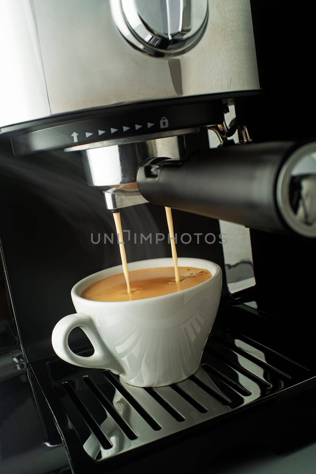 Espresso pouring from coffee machine. Professional coffee brewing