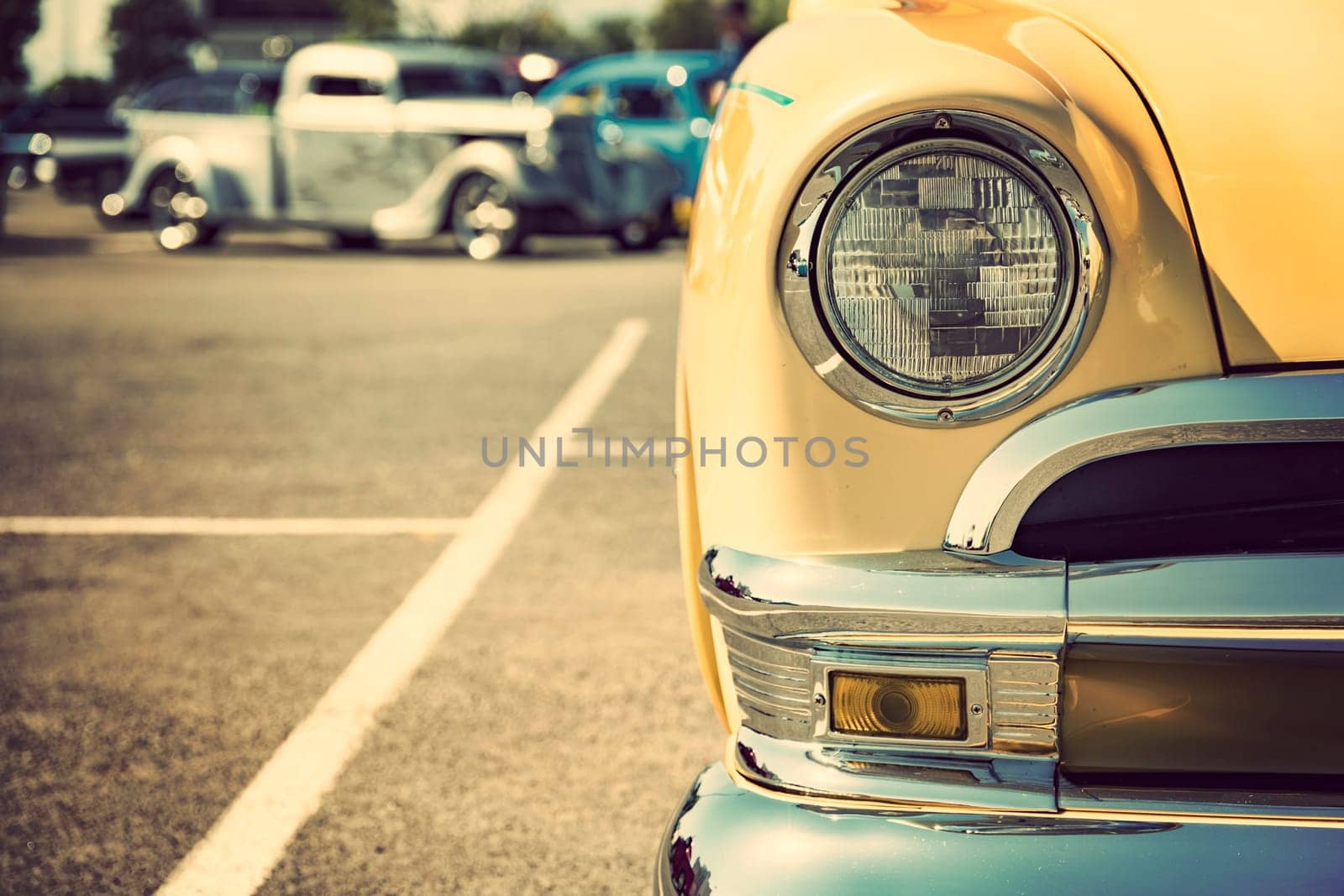 Photograph of a classic vehicle with close-up on headlights.
