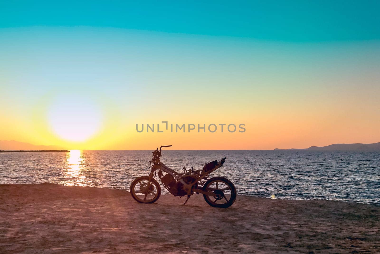 Burned abandoned motorcycle on the beach - Zakynthos / Zante Island, Greece