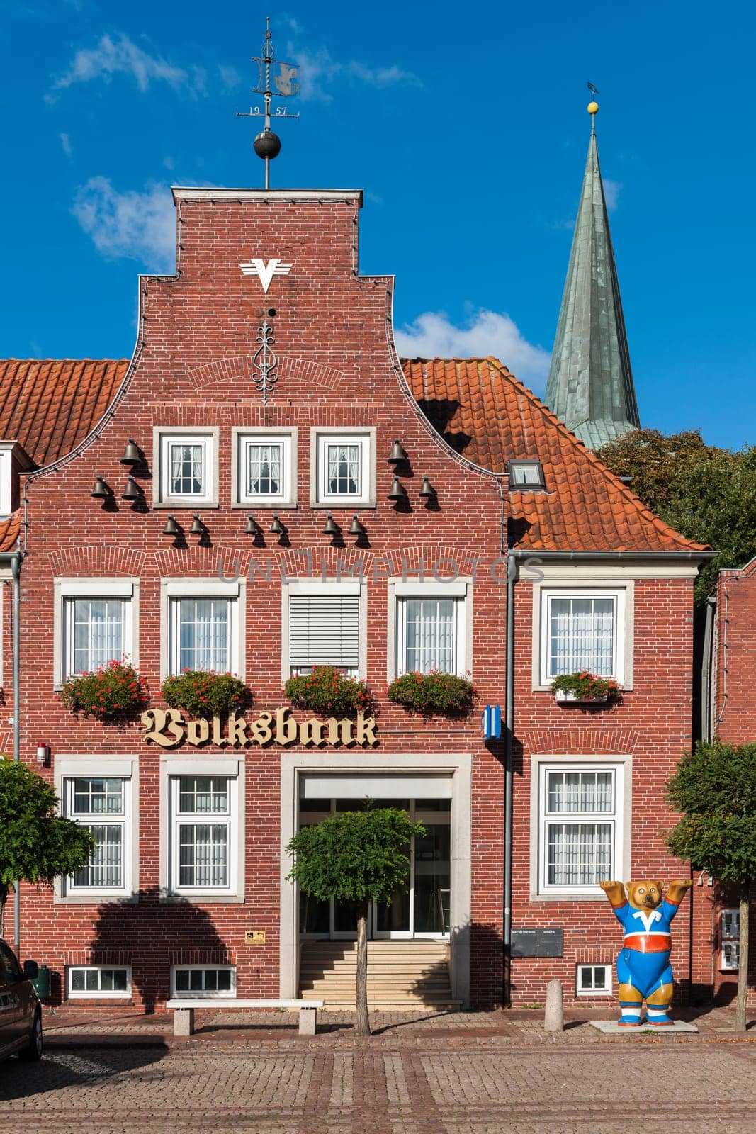Esens,Germany - October 5,2016: House with brick façade with carillon,tower ball and wind vane on the market square in Esens.